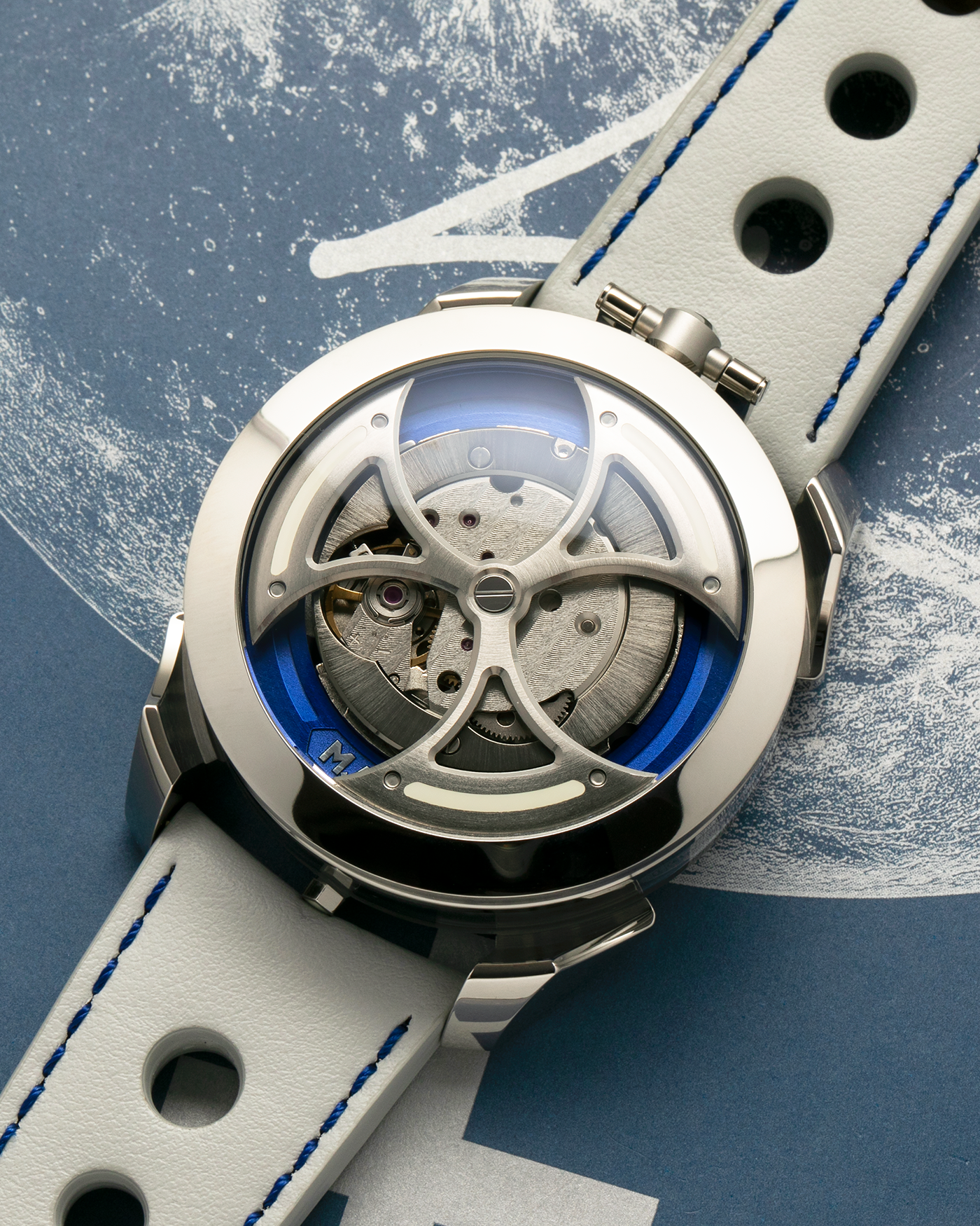 Brand: MB&F
Year: 2021
Model: MAD 1 Blue
Material: Stainless Steel and Titanium
Movement: Miyota Cal. 821A, Self-Winding
Case Dimensions: 42mm x 18.8mm (Lug-to-Lug 50.5mm)
Strap: MB&F White Grey Leather Rally Strap with Signed Stainless Steel Deployant 