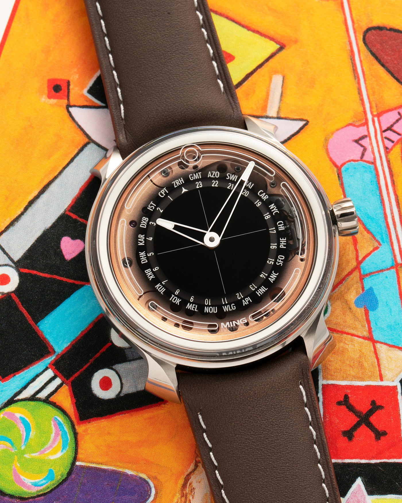 Brand: MING
Year: 2020
Model: 19.02 World Timer
Material: Grade 5 Titanium
Movement: Schwarz-Etienne for MING Cal. ASE 220.1, Manual-Winding
Case Dimensions: 39mm x 10.9mm (Lug-to-Lug 43.9mm)
Lug Width: 20mm
Straps: Jean Rousseau Brown Calf Leather Strap for MING with Signed Grade 5 Titanium Tang Buckle, additional Jean Rousseau Suede Black Leather Strap with Contrasting Orange Stitching for MING with Signed Grade 5 Titanium Tang Buckle