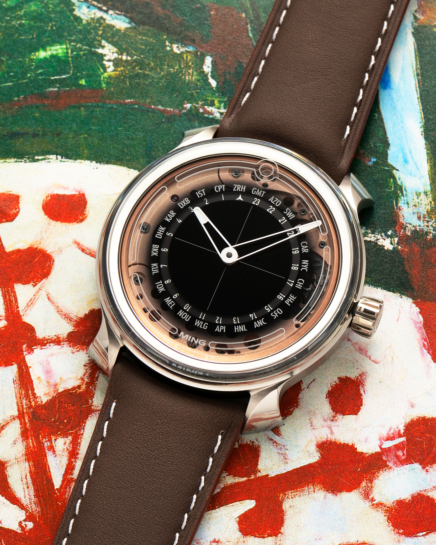 Brand: MING
Year: 2020
Model: 19.02 World Timer
Material: Grade 5 Titanium
Movement: Schwarz-Etienne for MING Cal. ASE 220.1, Manual-Winding
Case Dimensions: 39mm x 10.9mm (Lug-to-Lug 43.9mm)
Lug Width: 20mm
Straps: Jean Rousseau Brown Calf Leather Strap for MING with Signed Grade 5 Titanium Tang Buckle, additional Jean Rousseau Suede Black Leather Strap with Contrasting Orange Stitching for MING with Signed Grade 5 Titanium Tang Buckle