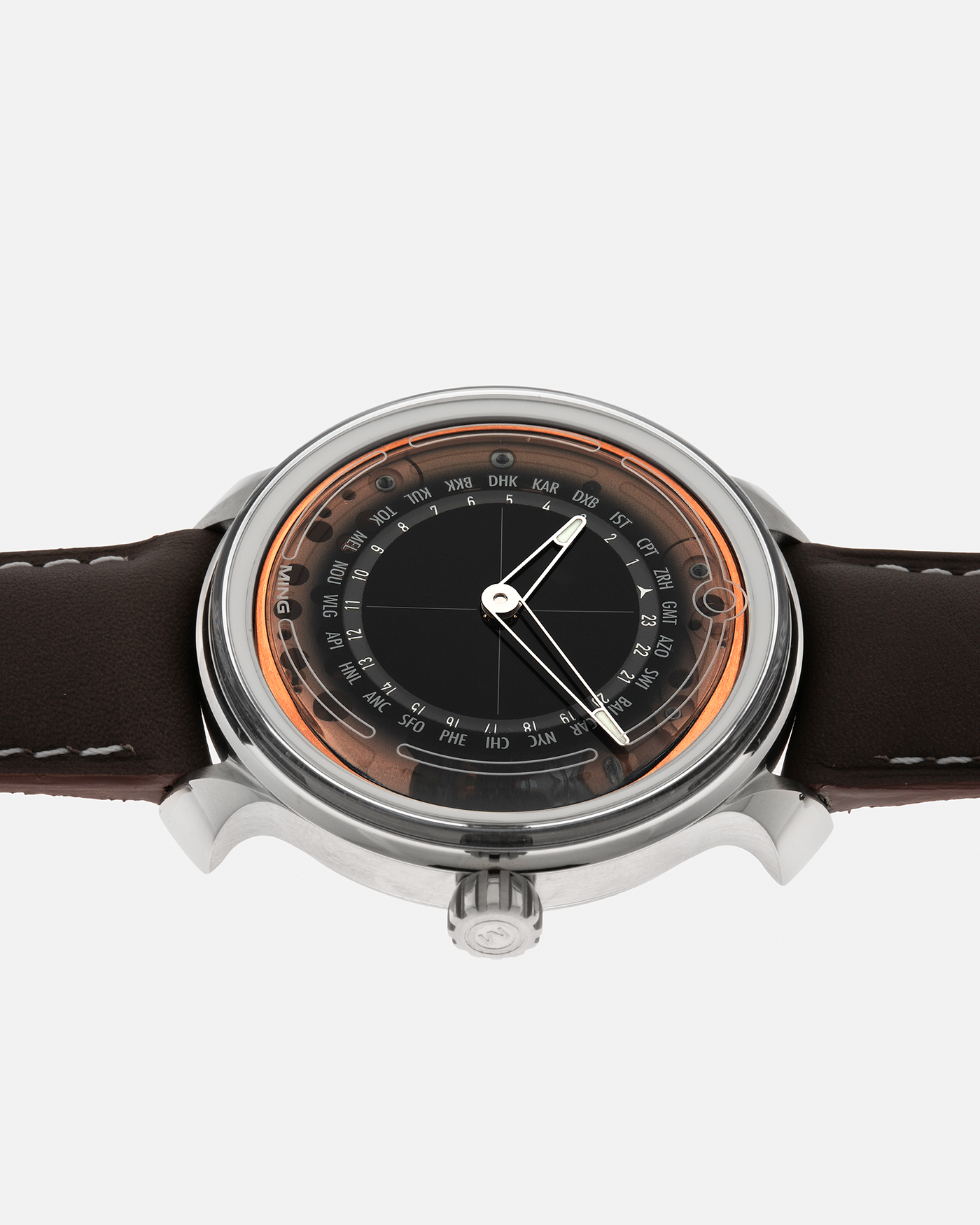 Brand: MING
Year: 2020
Model: 19.02 World Timer
Material: Grade 5 Titanium
Movement: Schwarz-Etienne for MING Cal. ASE 220.1, Manual-Winding
Case Dimensions: 39mm x 10.9mm (Lug-to-Lug 43.9mm)
Lug Width: 20mm
Straps: Jean Rousseau Brown Calf Leather Strap for MING with Signed Grade 5 Titanium Tang Buckle, additional Jean Rousseau Suede Black Leather Strap with Contrasting Orange Stitching for MING with Signed Grade 5 Titanium Tang Buckle