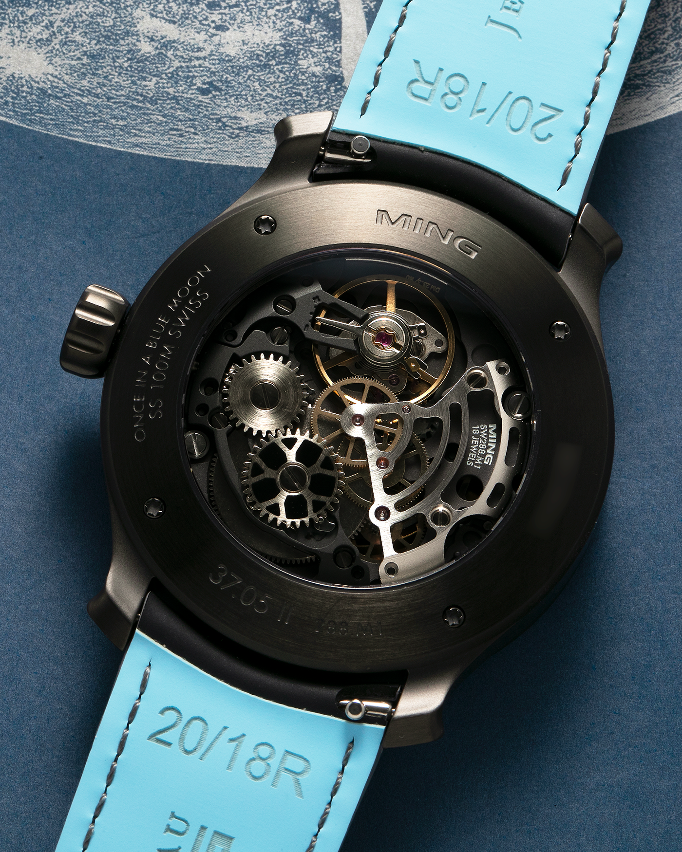 Brand: MING Year: 2023 Model: 37.05 Moonphase Series 2 Special Edition (Special Caves Project), Limited to 50 pieces Material: DLC-Coated Stainless Steel Movement: Heavily Modified Sellita Cal. SW288-1, Manual-Winding Case Diameter: 38mm Lug Width: 20mm Strap: Jean Rousseau Black Rubber with Blue Under Lining for MING with Signed DLC-Coated Keeperless Flying Blade Buckle