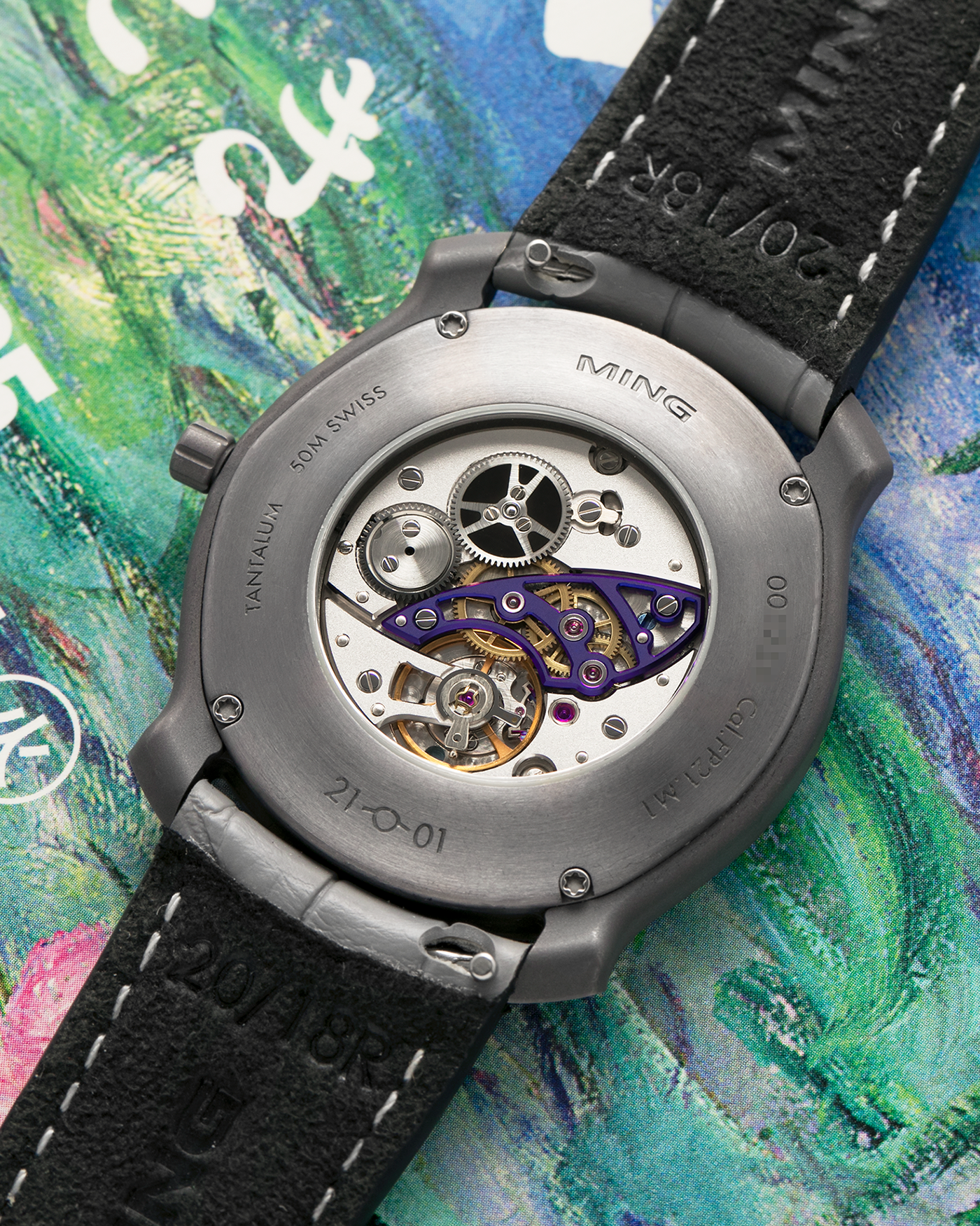 Brand: MING
Year: 2025
Model: Project 21 Souscription, Limited to 10 Pieces
Material: Tantalum Monobloc Case, FEMTOprint Borosilicate Crystal Dial, CVD-Coated Brass Dial Base
Movement: Heavily Modified Frederic Piguet Cal. 21, Manual-Winding
Case Dimensions: 35mm x 6.9mm (Lug-to-Lug 38.5mm)
Lug Width: 20mm
Strap: MING Dark Blue Alcantara Strap with Signed Tantalum Pin Buckle