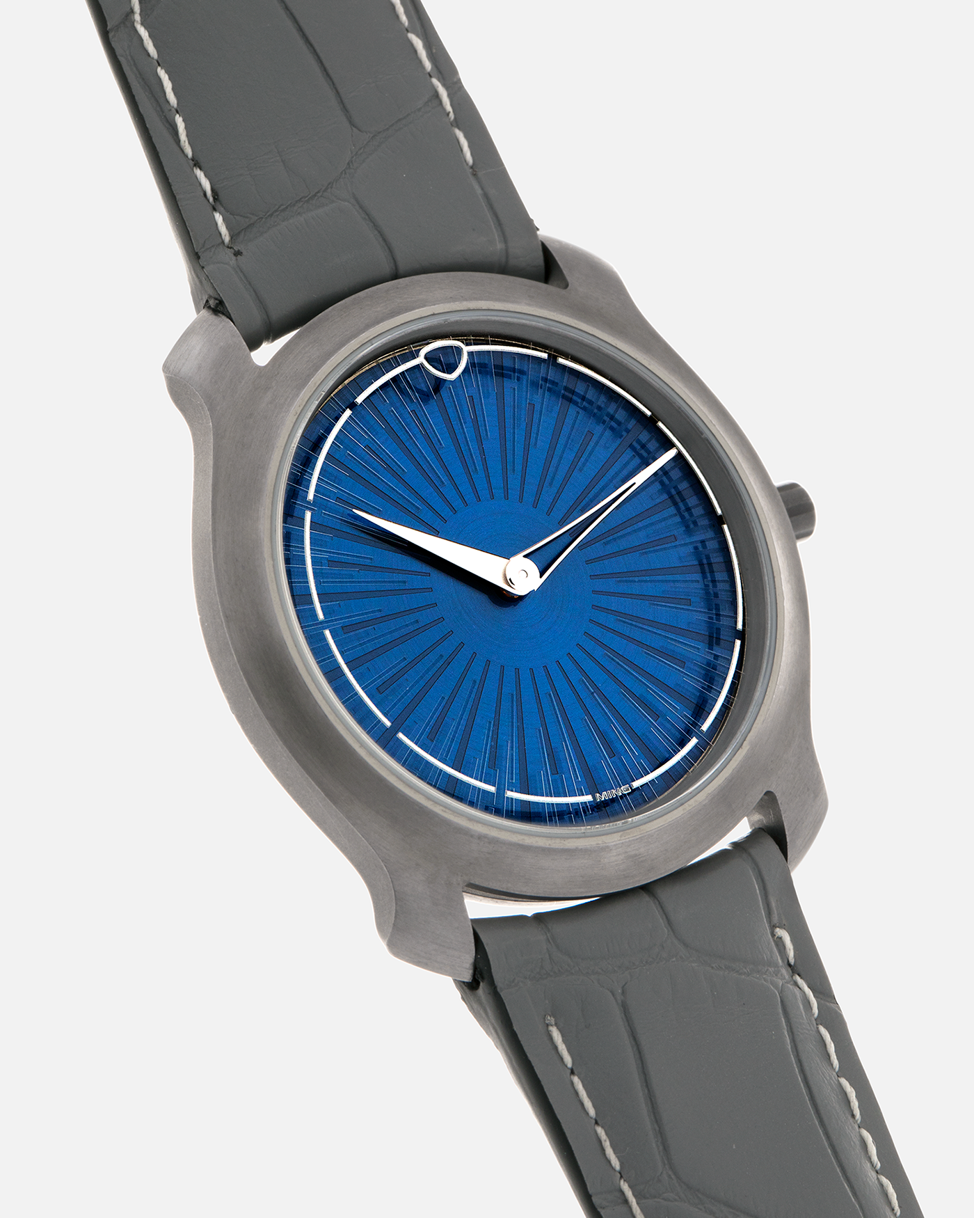 Brand: MING
Year: 2025
Model: Project 21 Souscription, Limited to 10 Pieces
Material: Tantalum Monobloc Case, FEMTOprint Borosilicate Crystal Dial, CVD-Coated Brass Dial Base
Movement: Heavily Modified Frederic Piguet Cal. 21, Manual-Winding
Case Dimensions: 35mm x 6.9mm (Lug-to-Lug 38.5mm)
Lug Width: 20mm
Strap: MING Dark Blue Alcantara Strap with Signed Tantalum Pin Buckle