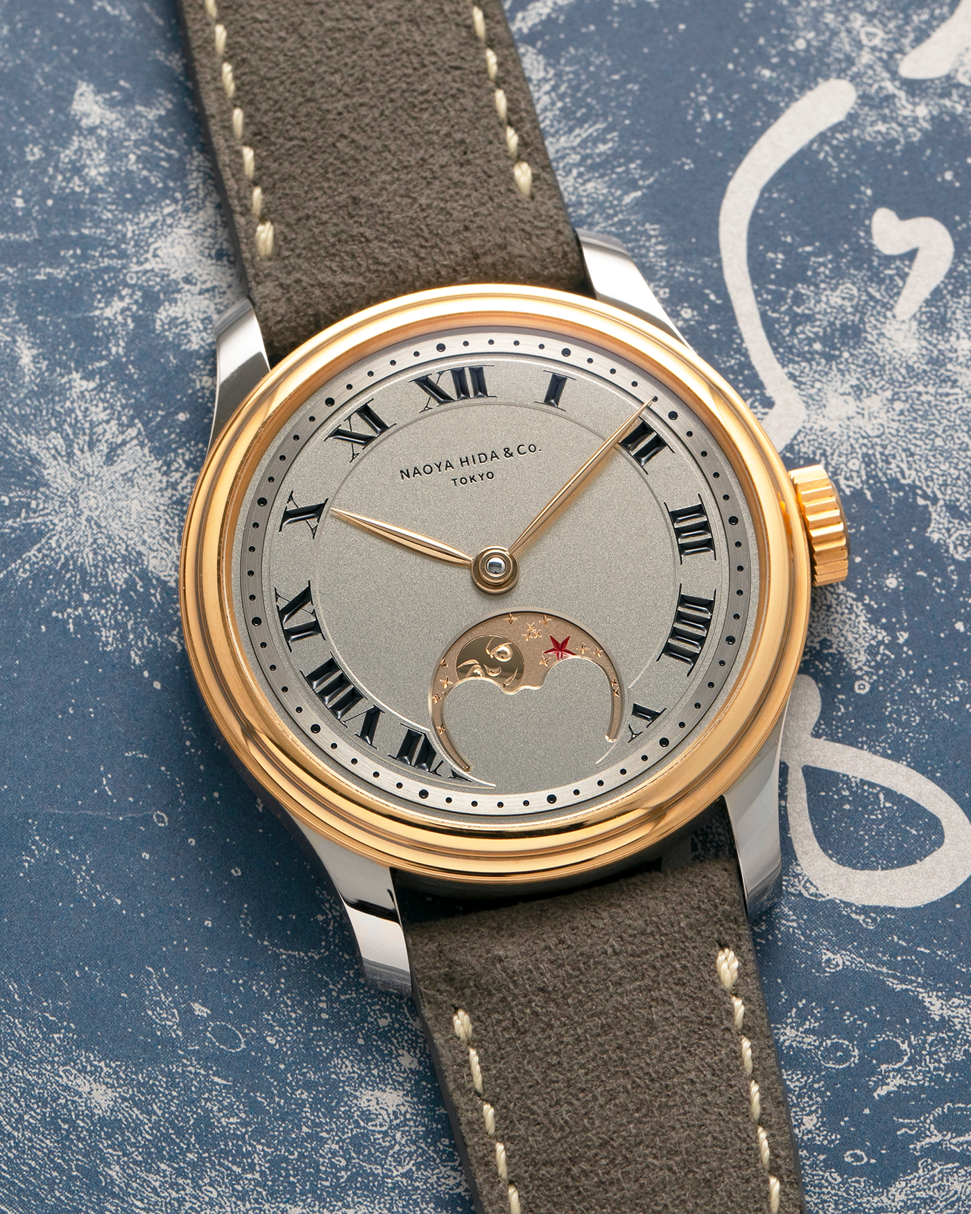 Brand: Naoya Hida
Year: 2025
Model: NH Type 3B-2, Revolution Magazine Limited Edition of 10 Pieces
Material: 904L Stainless Steel Case, German Silver Dial with Dark Grey DLC Treatment 
Movement: NH Cal. 3021LU (Based on Valjoux Cal. 7750), Manual-Winding
Case Dimensions: 37mm x 10.7mm (44mm Lug-to-Lug)
Lug Width: 20mm
Strap: Jean Rousseau Grey Suede Strap with Signed 904L Stainless Steel Tang Buckle