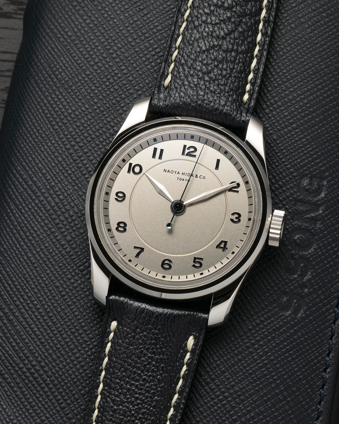 Brand: Naoya Hida
Year: 2024
Model: NH Type 4A
Material: 904L Stainless Steel Case, German Silver Dial
Movement: NH Cal. 3020SS (Based on Valjoux Cal. 7750), Manual-Winding
Case Dimensions: 36mm x 11mm (42mm Lug-to-Lug)
Lug Width: 20mm
Strap: Jean Rousseau Dark Brown Leather Strap with Signed 904L Stainless Steel Tang Buckle