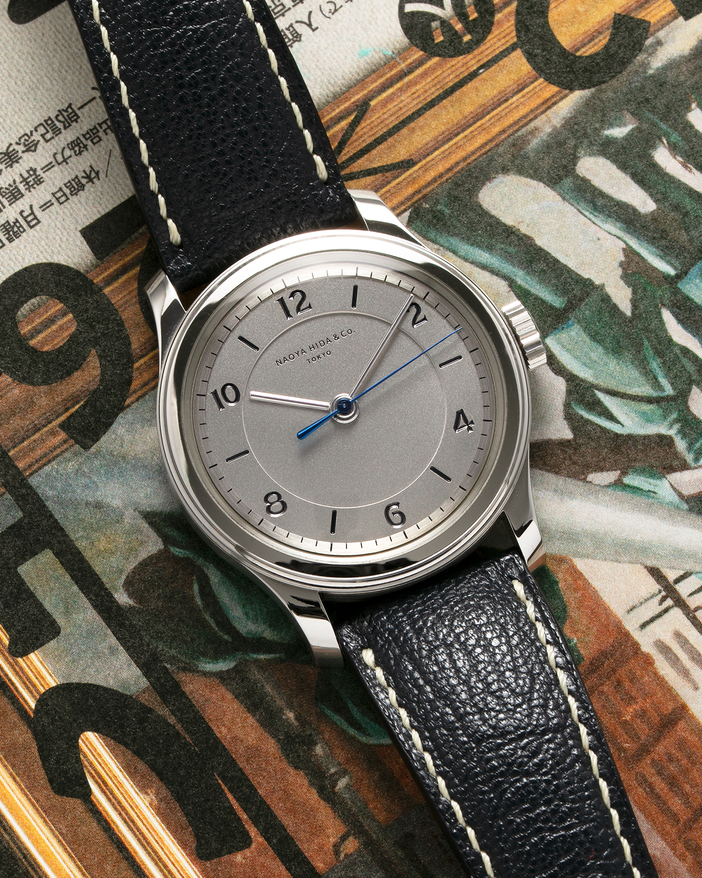 Brand: Naoya Hida Year: 2022 Model: NH Type 2B Material: 904L Stainless Steel Case, German Silver Dial  Movement: Cal. 3020CS, Manual-Winding Case Diameter: 37mm Strap: Naoya Hida (Jean Rousseau) Navy Blue Leather Strap with Contrasting Stitching and Signed Stainless Steel Tang Buckle