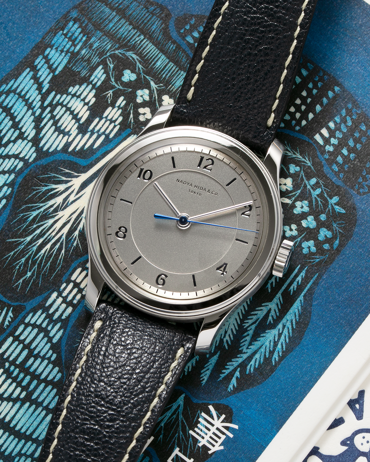 Brand: Naoya Hida Year: 2022 Model: NH Type 2B Material: 904L Stainless Steel Case, German Silver Dial  Movement: Cal. 3020CS, Manual-Winding Case Diameter: 37mm Strap: Naoya Hida (Jean Rousseau) Navy Blue Leather Strap with Contrasting Stitching and Signed Stainless Steel Tang Buckle