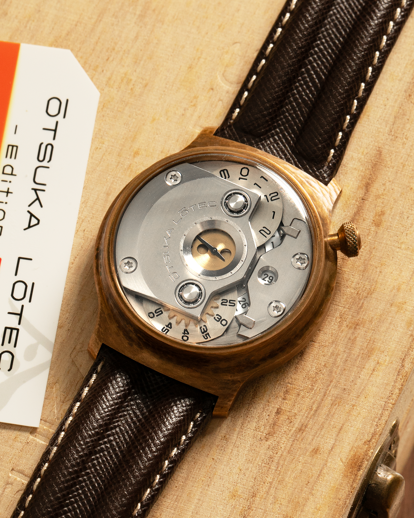 Brand: Otsuka Lotec
Year: 2020
Model: No.5 Bronze R-1 Reika
Material: Hand-Hammered Bronze with Stainless Steel Caseback
Movement: Modified Miyota Calibre 8215
Case Dimensions: 42mm Diameter 13.6mm Thickness
Strap: Brown Otsuka Lotec Leather Strap with Unsigned Otsuka Lotec Stainless Steel Tang Buckle