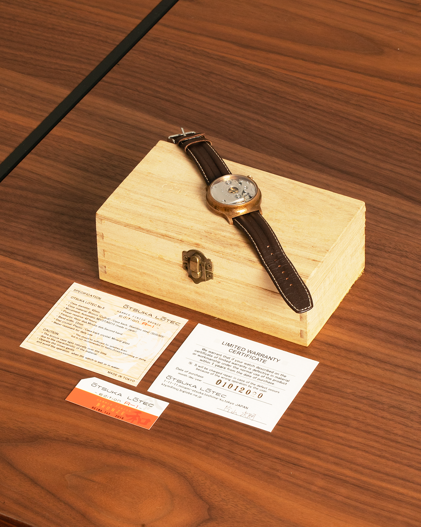 Brand: Otsuka Lotec
Year: 2020
Model: No.5 Bronze R-1 Reika
Material: Hand-Hammered Bronze with Stainless Steel Caseback
Movement: Modified Miyota Calibre 8215
Case Dimensions: 42mm Diameter 13.6mm Thickness
Strap: Brown Otsuka Lotec Leather Strap with Unsigned Otsuka Lotec Stainless Steel Tang Buckle