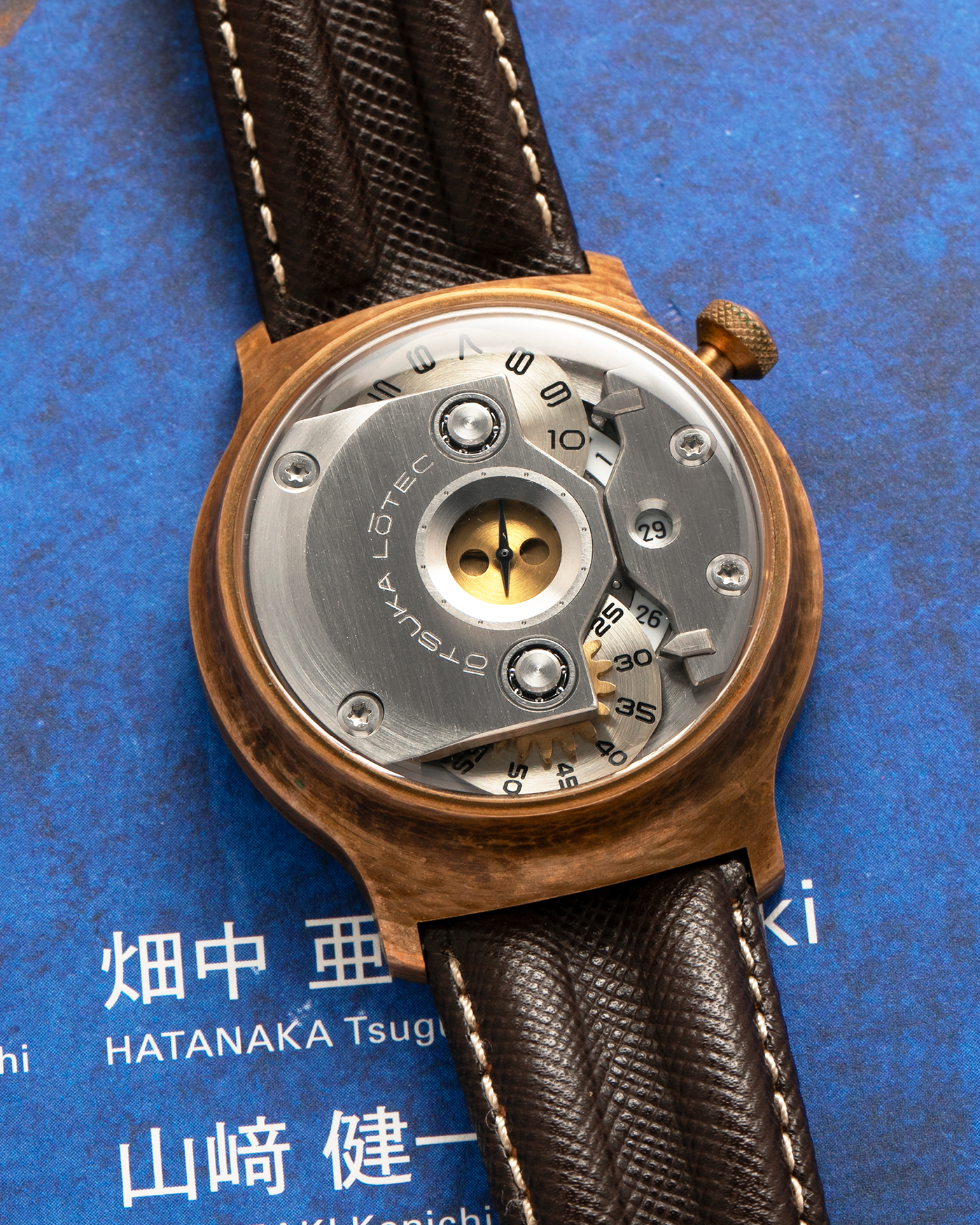 Brand: Otsuka Lotec
Year: 2020
Model: No.5 Bronze R-1 Reika
Material: Hand-Hammered Bronze with Stainless Steel Caseback
Movement: Modified Miyota Calibre 8215
Case Dimensions: 42mm Diameter 13.6mm Thickness
Strap: Brown Otsuka Lotec Leather Strap with Unsigned Otsuka Lotec Stainless Steel Tang Buckle