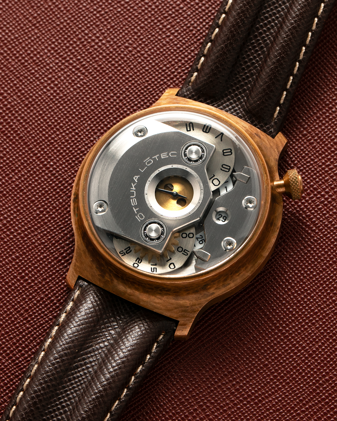Brand: Otsuka Lotec
Year: 2020
Model: No.5 Bronze R-1 Reika
Material: Hand-Hammered Bronze with Stainless Steel Caseback
Movement: Modified Miyota Calibre 8215
Case Dimensions: 42mm Diameter 13.6mm Thickness
Strap: Brown Otsuka Lotec Leather Strap with Unsigned Otsuka Lotec Stainless Steel Tang Buckle