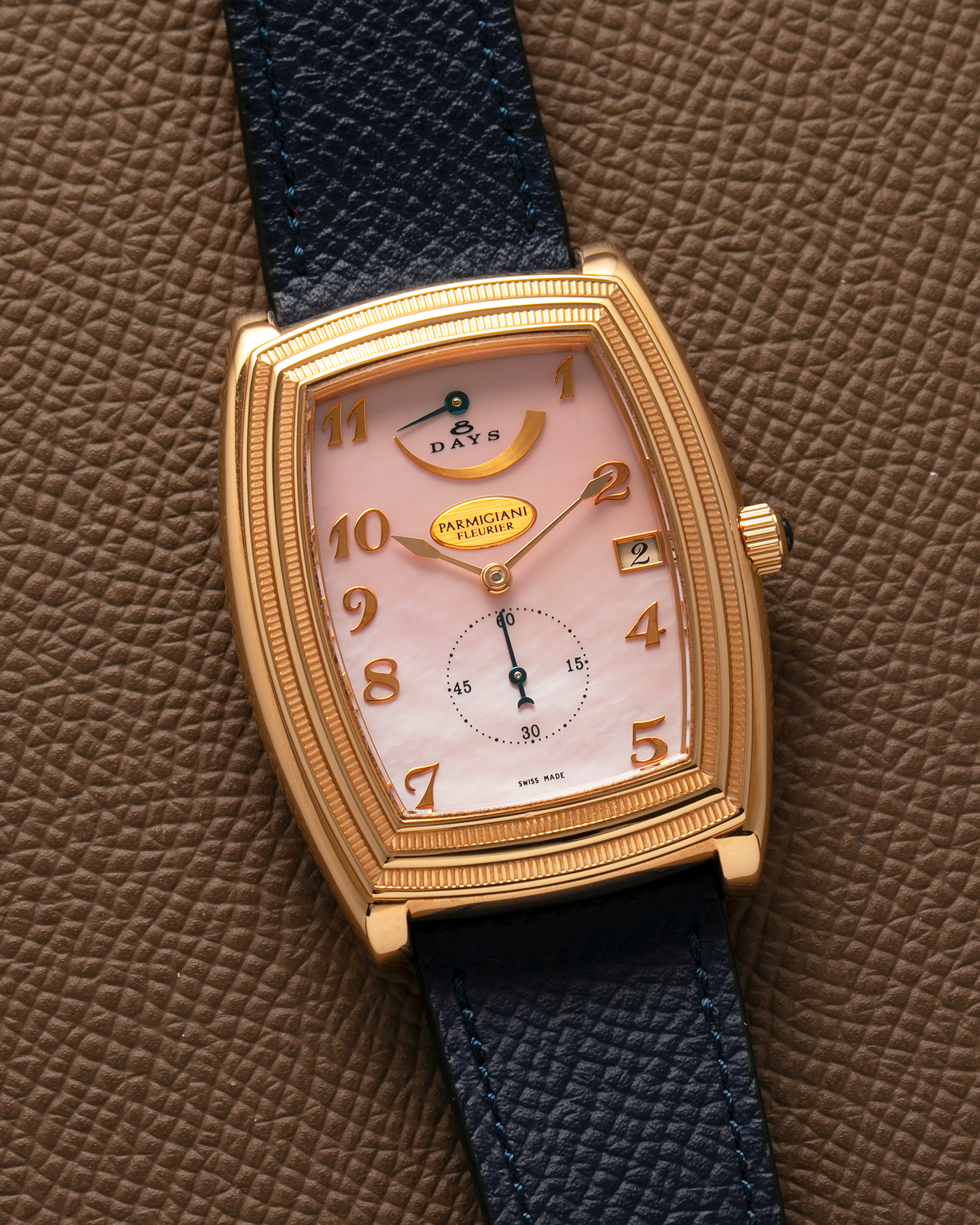 Brand: Parmigiani Fleurier
Year: 2000s
Model: Ionica Hebdomadaire 8-Days ‘Mother-of-Pearl’
Material: 18-carat Rose Gold, Mother-of-Pearl Dial
Movement: Parmigiani Fleurier Cal. PF 110, Manual-Winding
Case Dimensions: 45mm (Including Lugs) x 36mm x 11mm
Lug Width: 20mm
Strap: Nostime Dark Navy Grained Calf Leather Strap with 18-carat Rose Gold Signed Tang Buckle