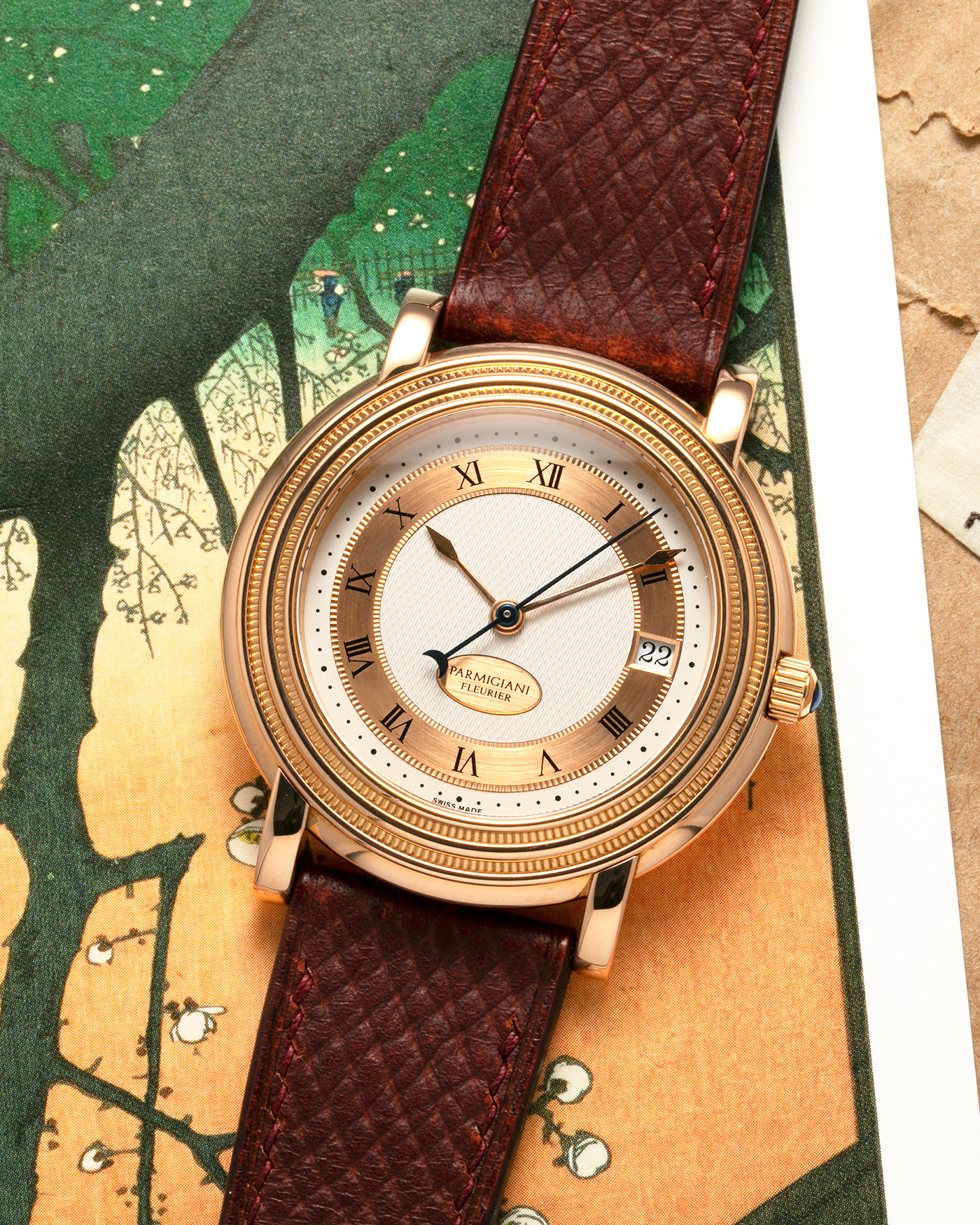 Brand: Parmigiani Fleurier
Year: 1990s
Model: Toric Automatic
Material: 18-carat Rose Gold
Movement: PF Cal. 13301, Self-Winding
Case Dimensions: 40mm x 8mm (Lug-to-Lug 44mm)
Lug Width: 20mm
Strap: Delugs Wine Red Alligator Leather Strap with Signed 18-carat Rose Gold Tang Buckle
