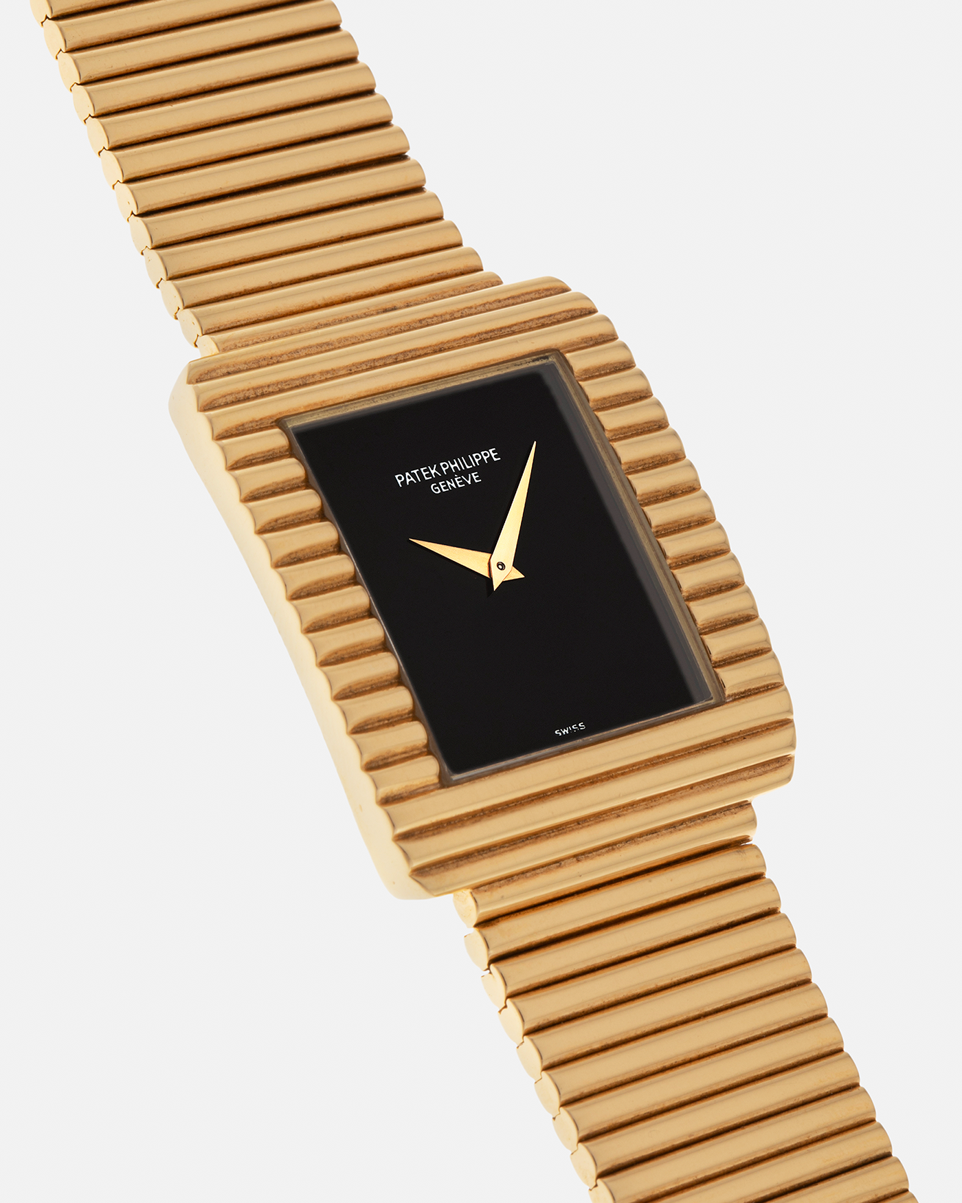 Brand: Patek Philippe
Year: 1976
Model: Gondolo
Reference Number: 3733J
Material: 18-carat Yellow Gold Case, Black Onyx Stone Dial
Movement: Patek Philippe Cal. 215, Manual-Winding
Case Dimensions: 29mm x 33mm (Including Lugs) x 6.5mm
Bracelet: Patek Philippe Ribbed Integrated Bracelet in 18-carat Yellow Gold with Signed Clasp