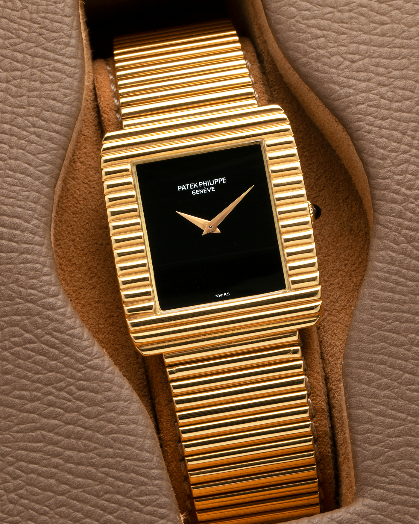 Brand: Patek Philippe
Year: 1976
Model: Gondolo
Reference Number: 3733J
Material: 18-carat Yellow Gold Case, Black Onyx Stone Dial
Movement: Patek Philippe Cal. 215, Manual-Winding
Case Dimensions: 29mm x 33mm (Including Lugs) x 6.5mm
Bracelet: Patek Philippe Ribbed Integrated Bracelet in 18-carat Yellow Gold with Signed Clasp