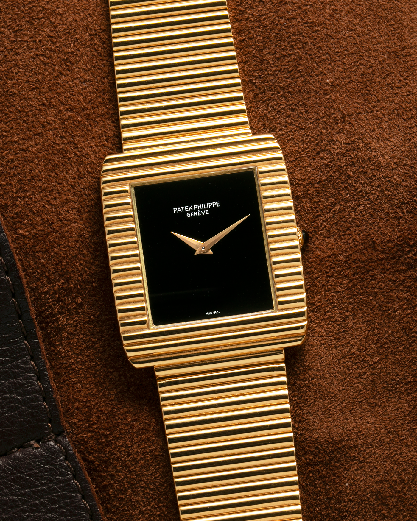 Brand: Patek Philippe
Year: 1976
Model: Gondolo
Reference Number: 3733J
Material: 18-carat Yellow Gold Case, Black Onyx Stone Dial
Movement: Patek Philippe Cal. 215, Manual-Winding
Case Dimensions: 29mm x 33mm (Including Lugs) x 6.5mm
Bracelet: Patek Philippe Ribbed Integrated Bracelet in 18-carat Yellow Gold with Signed Clasp