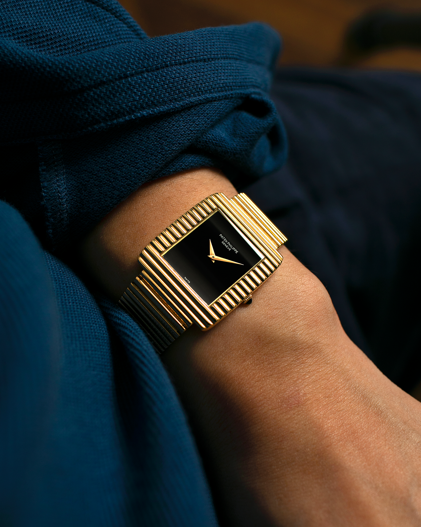Brand: Patek Philippe
Year: 1976
Model: Gondolo
Reference Number: 3733J
Material: 18-carat Yellow Gold Case, Black Onyx Stone Dial
Movement: Patek Philippe Cal. 215, Manual-Winding
Case Dimensions: 29mm x 33mm (Including Lugs) x 6.5mm
Bracelet: Patek Philippe Ribbed Integrated Bracelet in 18-carat Yellow Gold with Signed Clasp