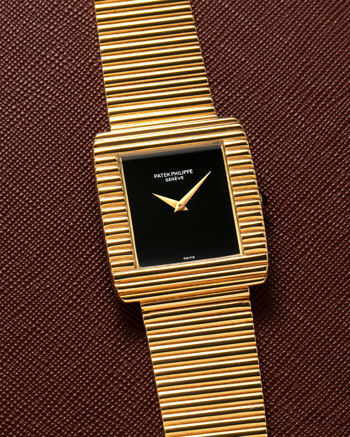 Brand: Patek Philippe
Year: 1976
Model: Gondolo
Reference Number: 3733J
Material: 18-carat Yellow Gold Case, Black Onyx Stone Dial
Movement: Patek Philippe Cal. 215, Manual-Winding
Case Dimensions: 29mm x 33mm (Including Lugs) x 6.5mm
Bracelet: Patek Philippe Ribbed Integrated Bracelet in 18-carat Yellow Gold with Signed Clasp
