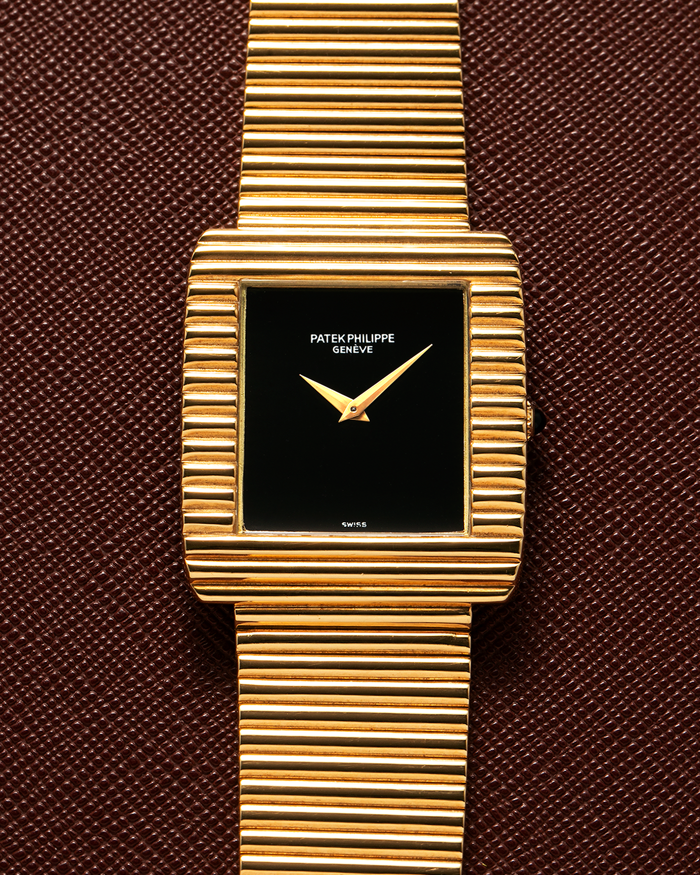 Brand: Patek Philippe
Year: 1976
Model: Gondolo
Reference Number: 3733J
Material: 18-carat Yellow Gold Case, Black Onyx Stone Dial
Movement: Patek Philippe Cal. 215, Manual-Winding
Case Dimensions: 29mm x 33mm (Including Lugs) x 6.5mm
Bracelet: Patek Philippe Ribbed Integrated Bracelet in 18-carat Yellow Gold with Signed Clasp