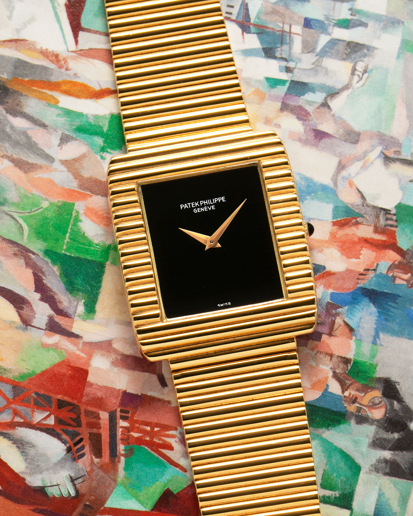 Brand: Patek Philippe
Year: 1976
Model: Gondolo
Reference Number: 3733J
Material: 18-carat Yellow Gold Case, Black Onyx Stone Dial
Movement: Patek Philippe Cal. 215, Manual-Winding
Case Dimensions: 29mm x 33mm (Including Lugs) x 6.5mm
Bracelet: Patek Philippe Ribbed Integrated Bracelet in 18-carat Yellow Gold with Signed Clasp