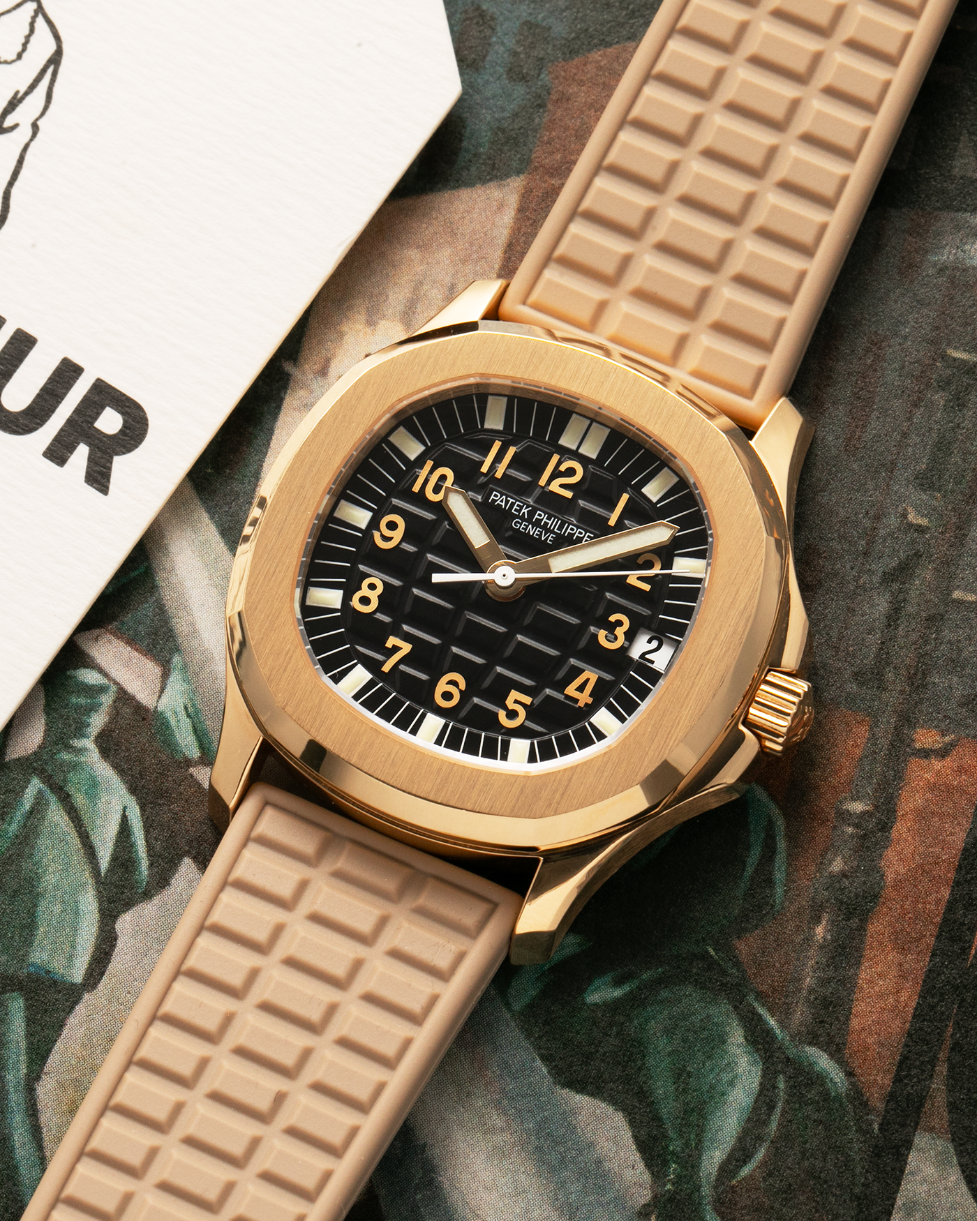 Brand: Patek Philippe
Year: 2004
Model: Aquanaut
Reference: 5066J
Material: 18k Yellow Gold
Movement: Patek Philippe Cal. 330 SC, Self-Winding
Case Dimensions: 36mm x 8.5mm
Lug Width: 19mm
Straps: Patek Philippe Beige ‘Tropic’ Rubber Strap with Signed 18k Yellow Gold Butterfly Double Fold Deployant Clasp. Extra Patek Philippe Khaki Green Rubber Strap.