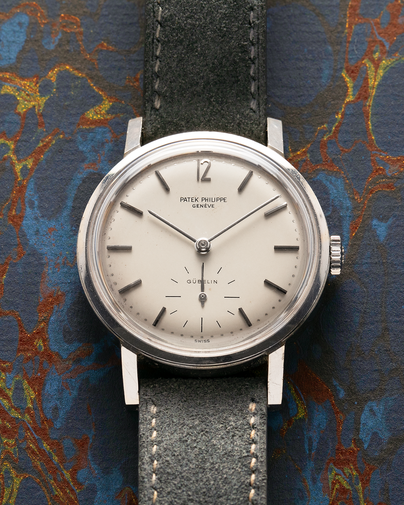 Brand: Patek Philippe
Year: 1966
Model: Calatrava, Gubelin Signed
Reference: 3417
Material: Stainless Steel
Movement: Patek Philippe Cal. 27-AM 400
Case Dimensions: 35mm Diameter 11mm Thickness
Lug Width: 18mm
Strap: Dream Rocketeers Grey Suede Strap with Generic Stainless Steel Buckle