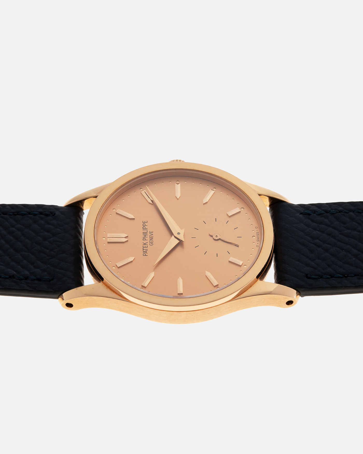 Brand: Patek Philippe
Year: 1993
Model: Calatrava
Reference: 3796R
Material: 18-carat Rose Gold
Movement: Patek Philippe Cal. 215 PS, Manual-Winding
Case Dimensions: 31mm x 7mm (Lug-to-Lug 37mm)
Lug Width: 18mm
Strap: Patek Philippe Black Alligator Leather Strap with Signed 18-carat Rose Gold Tang Buckle, additional Nostime Dark Navy Textured Calf Leather Strap