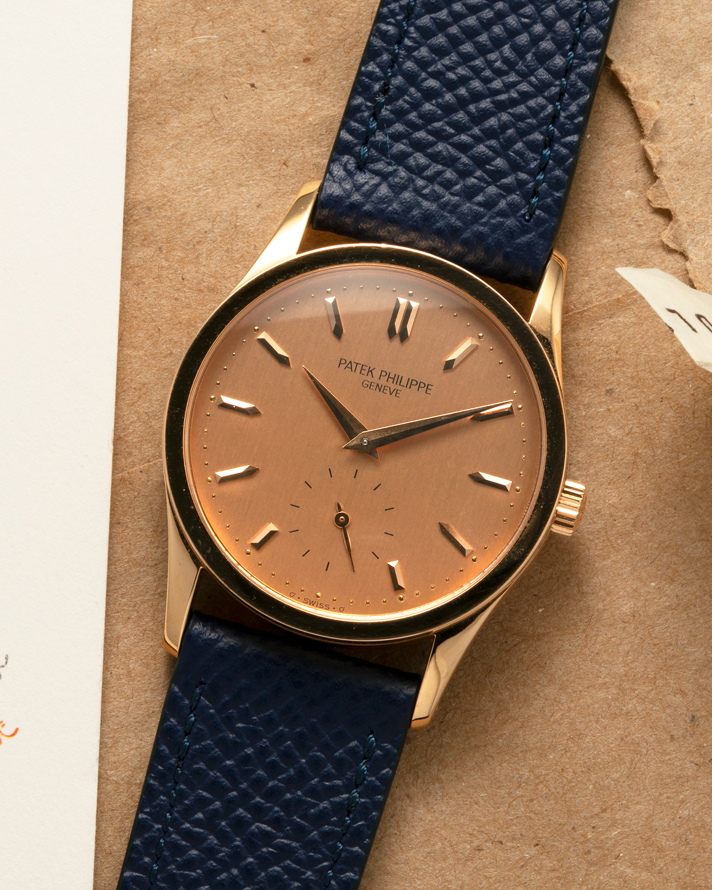 Brand: Patek Philippe
Year: 1993
Model: Calatrava
Reference: 3796R
Material: 18-carat Rose Gold
Movement: Patek Philippe Cal. 215 PS, Manual-Winding
Case Dimensions: 31mm x 7mm (Lug-to-Lug 37mm)
Lug Width: 18mm
Strap: Patek Philippe Black Alligator Leather Strap with Signed 18-carat Rose Gold Tang Buckle, additional Nostime Dark Navy Textured Calf Leather Strap