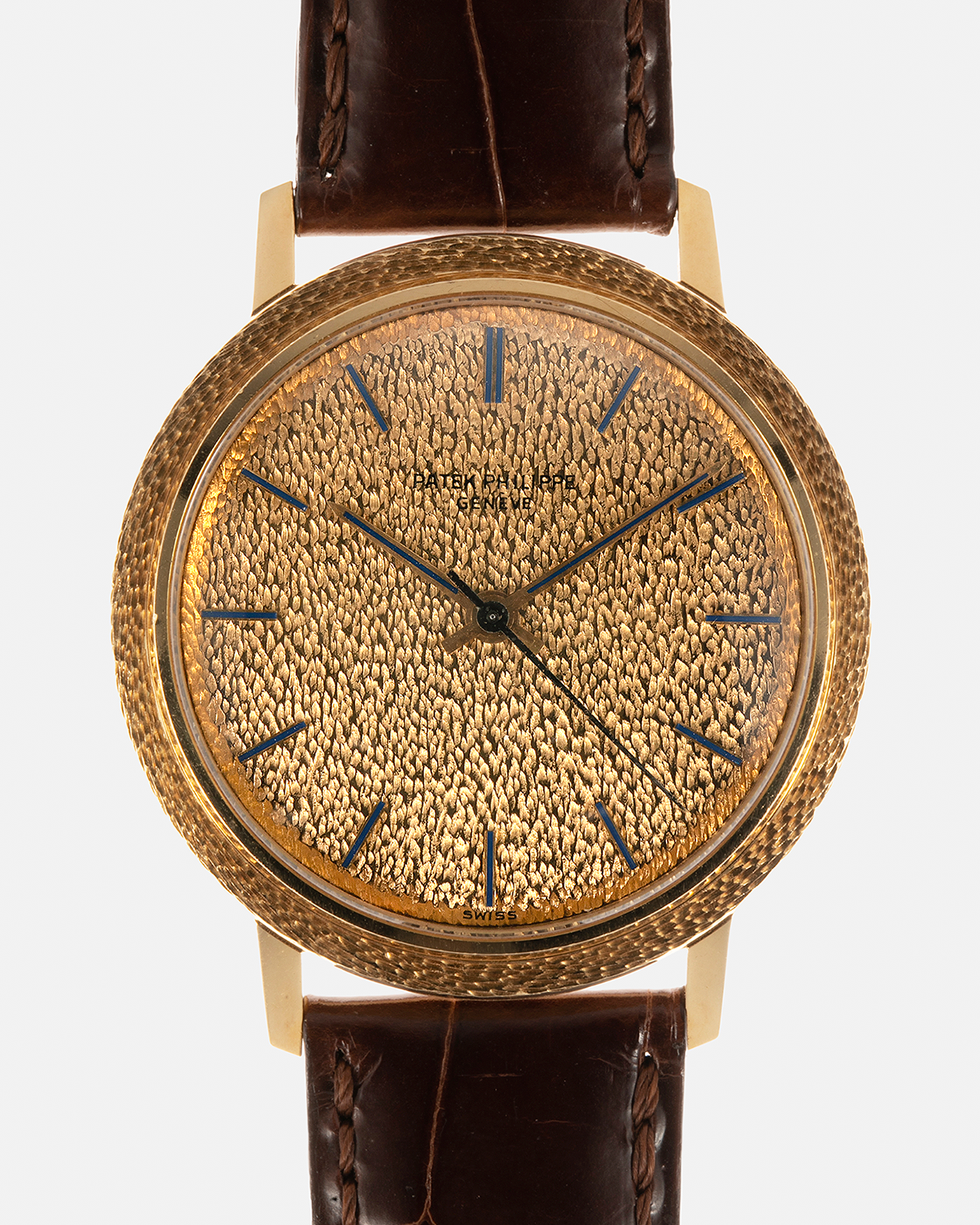 Brand: Patek Philippe
Year: 1970
Model: Calatrava ‘Back Wind’ Hammered
Reference Number: 3569J
Material: 18-carat Yellow Gold
Movement: Patek Philippe Back-Wind Cal. 350, Self-Winding
Case Dimensions: 36mm x 8.3mm (Lug-to-Lug 41mm)
Lug Width: 18mm
Strap: Patek Philippe Dark Brown Alligator Leather Strap with Signed 18-carat Yellow Gold Tang Buckle