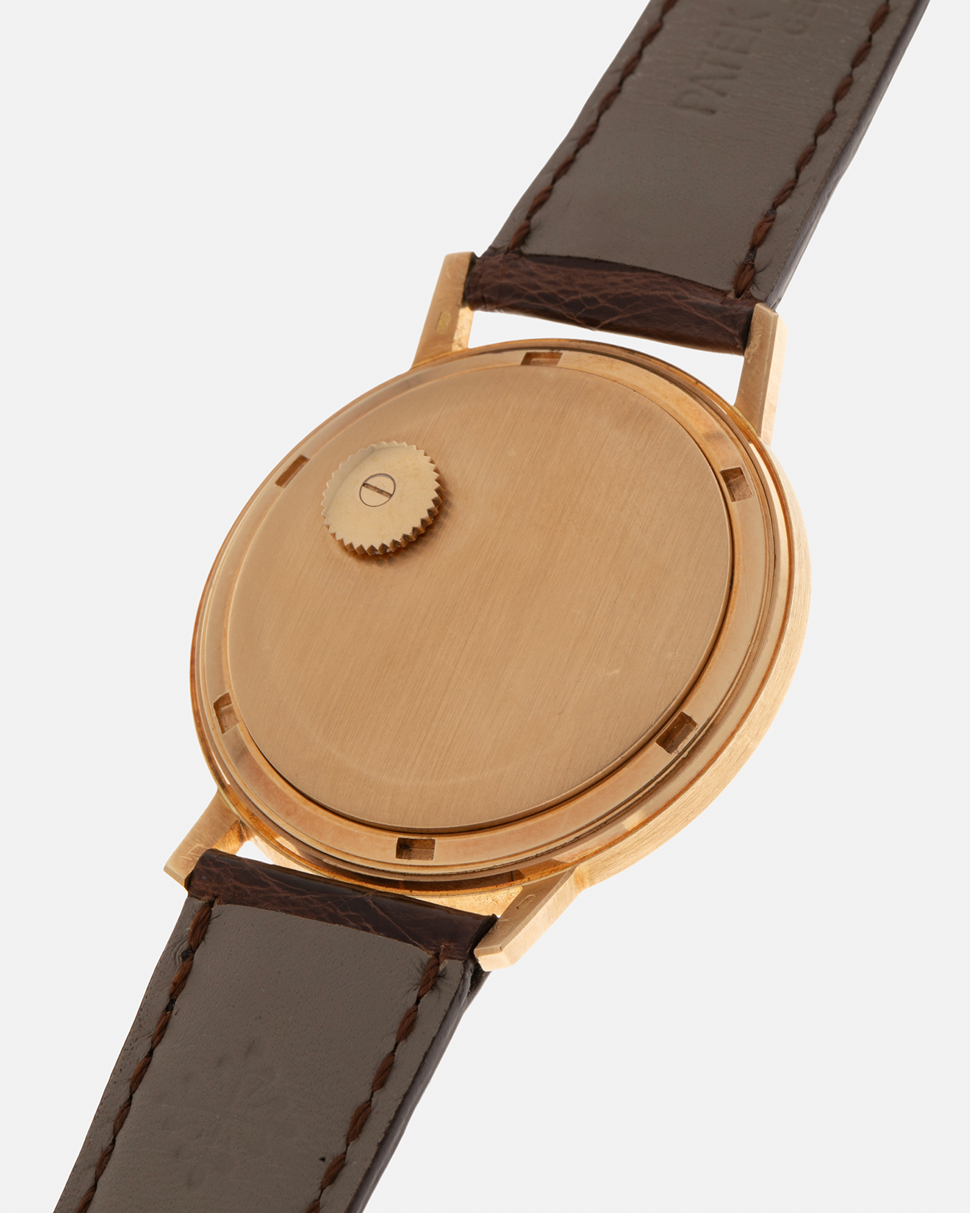Brand: Patek Philippe
Year: 1970
Model: Calatrava ‘Back Wind’ Hammered
Reference Number: 3569J
Material: 18-carat Yellow Gold
Movement: Patek Philippe Back-Wind Cal. 350, Self-Winding
Case Dimensions: 36mm x 8.3mm (Lug-to-Lug 41mm)
Lug Width: 18mm
Strap: Patek Philippe Dark Brown Alligator Leather Strap with Signed 18-carat Yellow Gold Tang Buckle