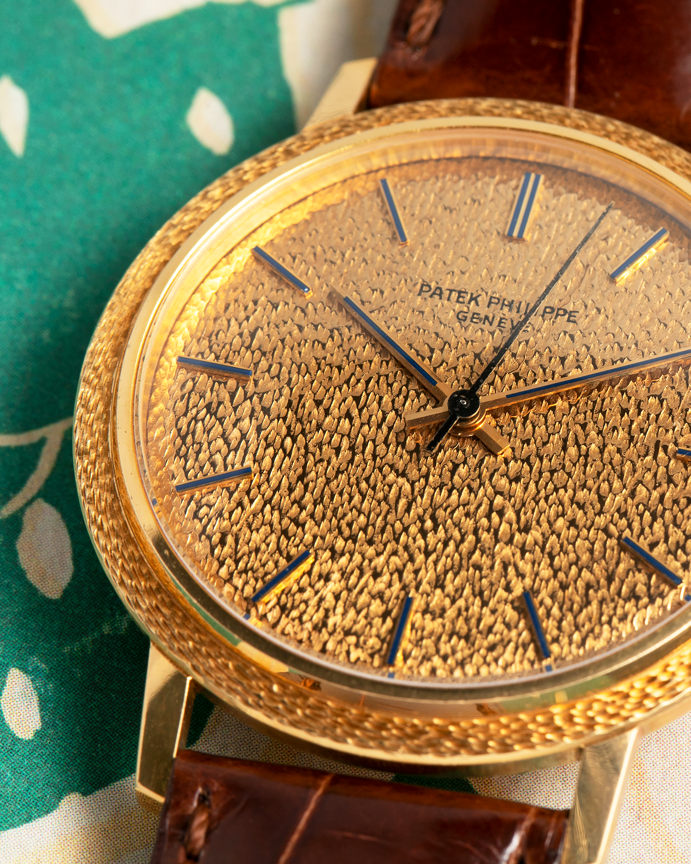 Brand: Patek Philippe
Year: 1970
Model: Calatrava ‘Back Wind’ Hammered
Reference Number: 3569J
Material: 18-carat Yellow Gold
Movement: Patek Philippe Back-Wind Cal. 350, Self-Winding
Case Dimensions: 36mm x 8.3mm (Lug-to-Lug 41mm)
Lug Width: 18mm
Strap: Patek Philippe Dark Brown Alligator Leather Strap with Signed 18-carat Yellow Gold Tang Buckle