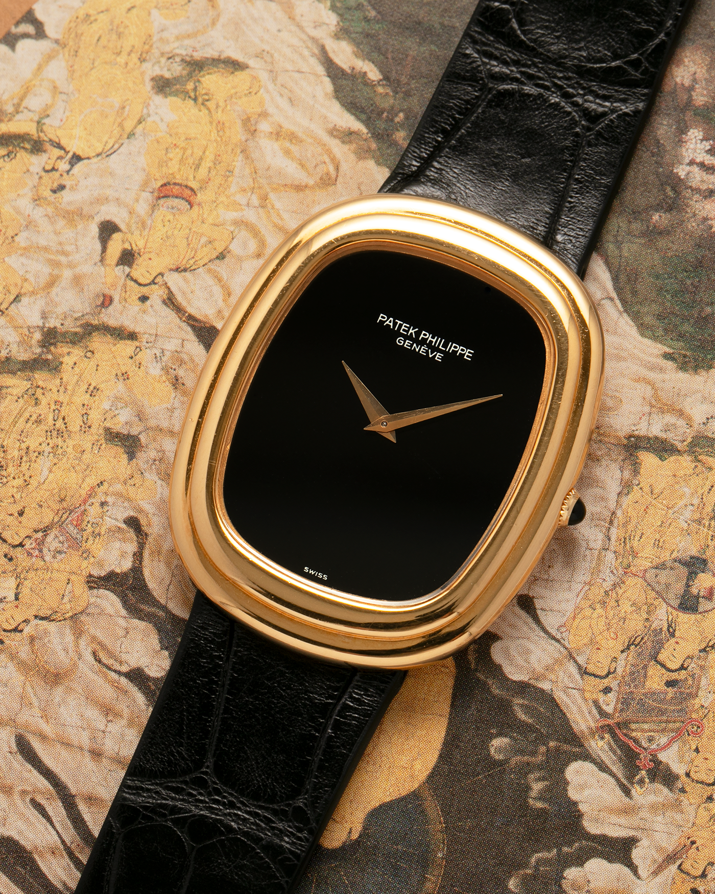 Brand: Patek Philippe
Year: 1977
Model: Ellipse
Reference Number: 3730
Material: 18-carat Yellow Gold Case, Onyx Dial
Movement: Patek Philippe Cal. 215, Manual-Winding
Case Dimensions: 31mm x 6mm (Lug-to-Lug 38.5mm)
Lug Width: 17mm
Strap: Custom Handdn Black Alligator Stitchless Leather Strap with Signed 18-carat Yellow Gold Ellipse Buckle
