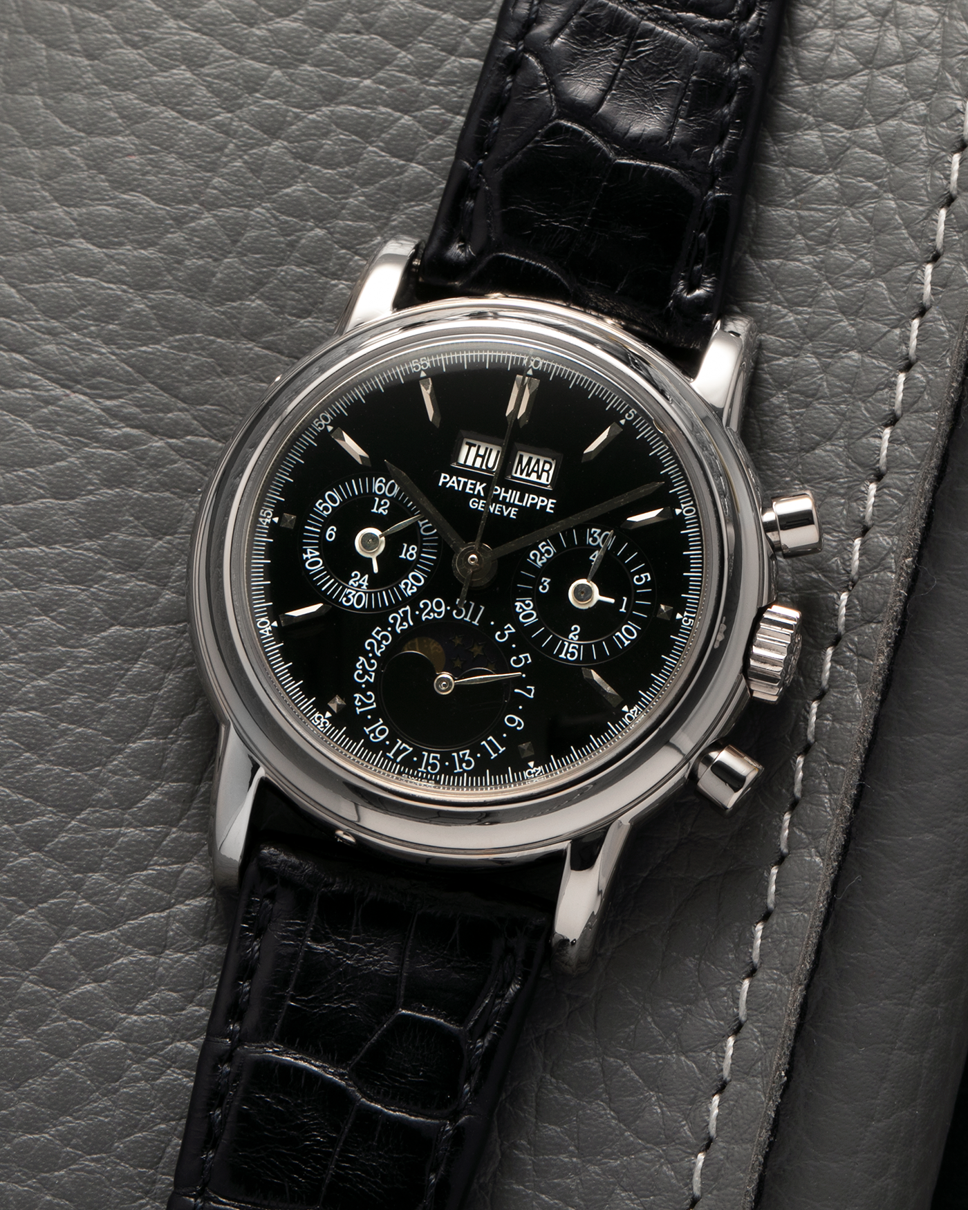 Brand: Patek Philippe
Year: 1995
Model: Perpetual Calendar Chronograph ‘4th Series’
Reference Number: 3970EG
Material: 18-carat White Gold
Movement: Patek Philippe Cal. 27-70 Q (Based on Lemania Cal. 2310), Self-Winding
Movement Number: 3045XXX
Case Dimensions: 36mm x 13mm (43.3mm Lug-to-Lug)
Lug Width: 19mm
Strap: Patek Philippe Black Alligator Leather Strap with Signed 18-carat White Gold Deployant Clasp