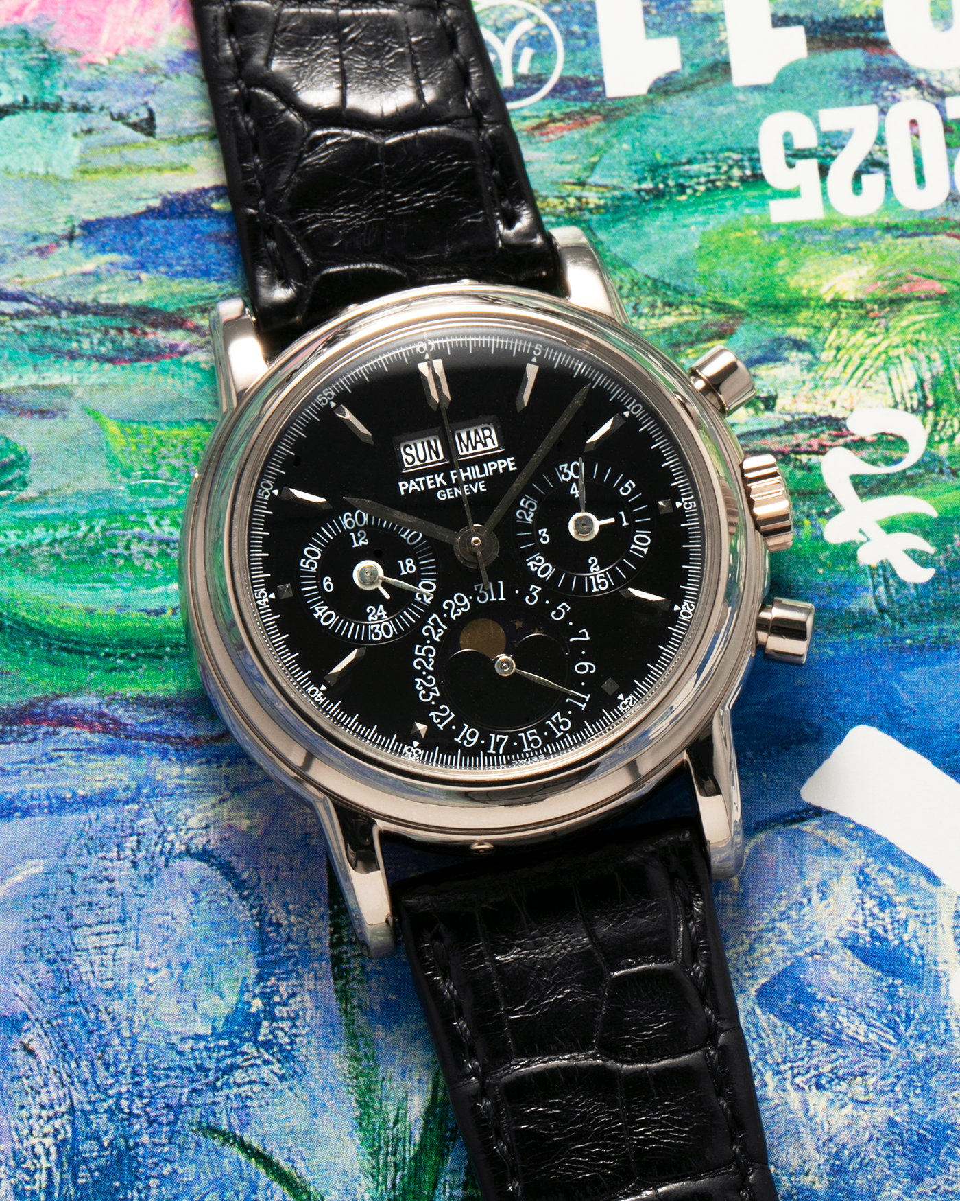 Brand: Patek Philippe
Year: 1995
Model: Perpetual Calendar Chronograph ‘4th Series’
Reference Number: 3970EG
Material: 18-carat White Gold
Movement: Patek Philippe Cal. 27-70 Q (Based on Lemania Cal. 2310), Self-Winding
Movement Number: 3045XXX
Case Dimensions: 36mm x 13mm (43.3mm Lug-to-Lug)
Lug Width: 19mm
Strap: Patek Philippe Black Alligator Leather Strap with Signed 18-carat White Gold Deployant Clasp