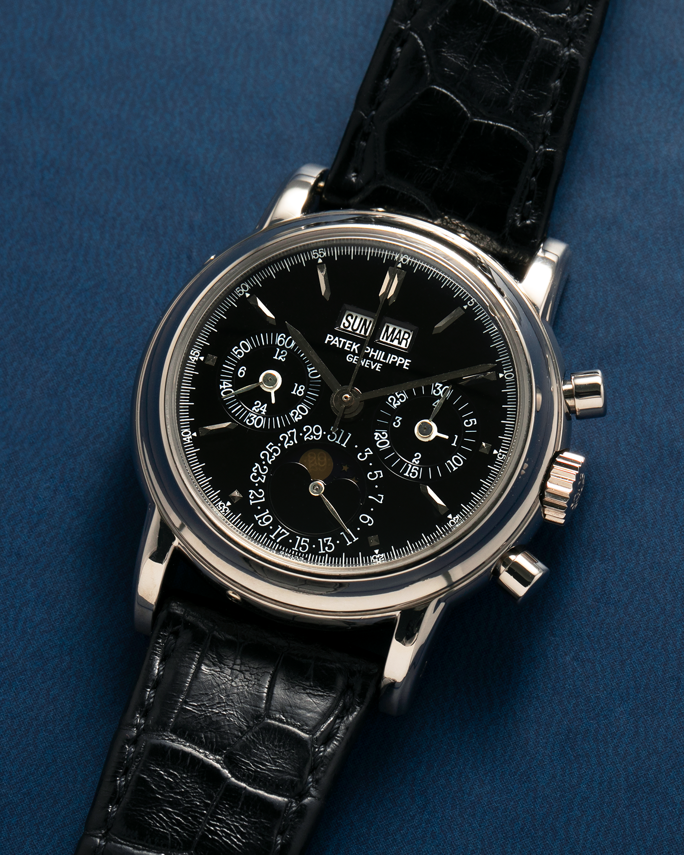 Brand: Patek Philippe
Year: 1995
Model: Perpetual Calendar Chronograph ‘4th Series’
Reference Number: 3970EG
Material: 18-carat White Gold
Movement: Patek Philippe Cal. 27-70 Q (Based on Lemania Cal. 2310), Self-Winding
Movement Number: 3045XXX
Case Dimensions: 36mm x 13mm (43.3mm Lug-to-Lug)
Lug Width: 19mm
Strap: Patek Philippe Black Alligator Leather Strap with Signed 18-carat White Gold Deployant Clasp