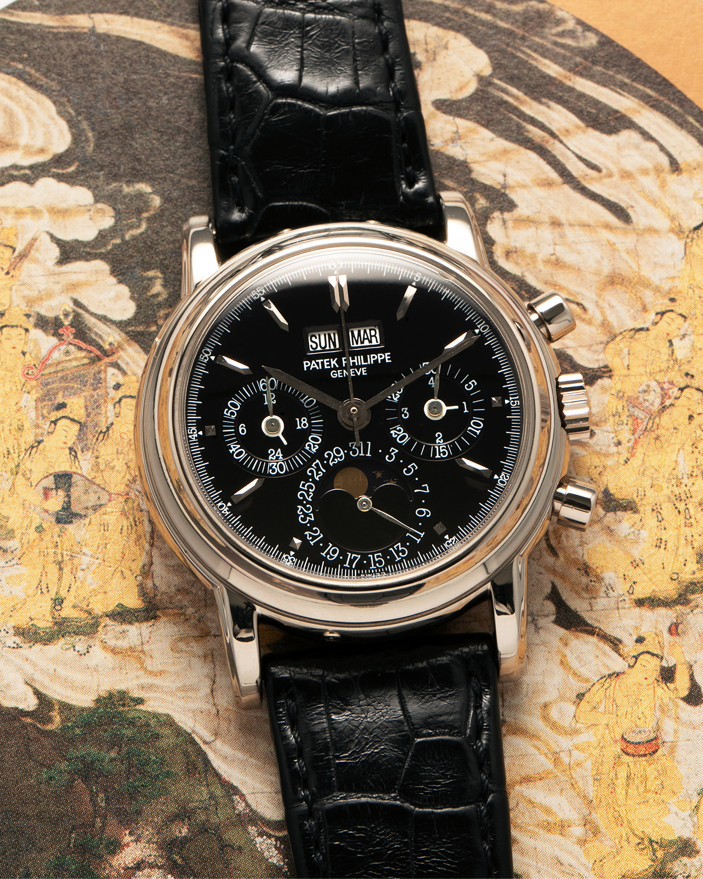 Brand: Patek Philippe
Year: 1995
Model: Perpetual Calendar Chronograph ‘4th Series’
Reference Number: 3970EG
Material: 18-carat White Gold
Movement: Patek Philippe Cal. 27-70 Q (Based on Lemania Cal. 2310), Self-Winding
Movement Number: 3045XXX
Case Dimensions: 36mm x 13mm (43.3mm Lug-to-Lug)
Lug Width: 19mm
Strap: Patek Philippe Black Alligator Leather Strap with Signed 18-carat White Gold Deployant Clasp