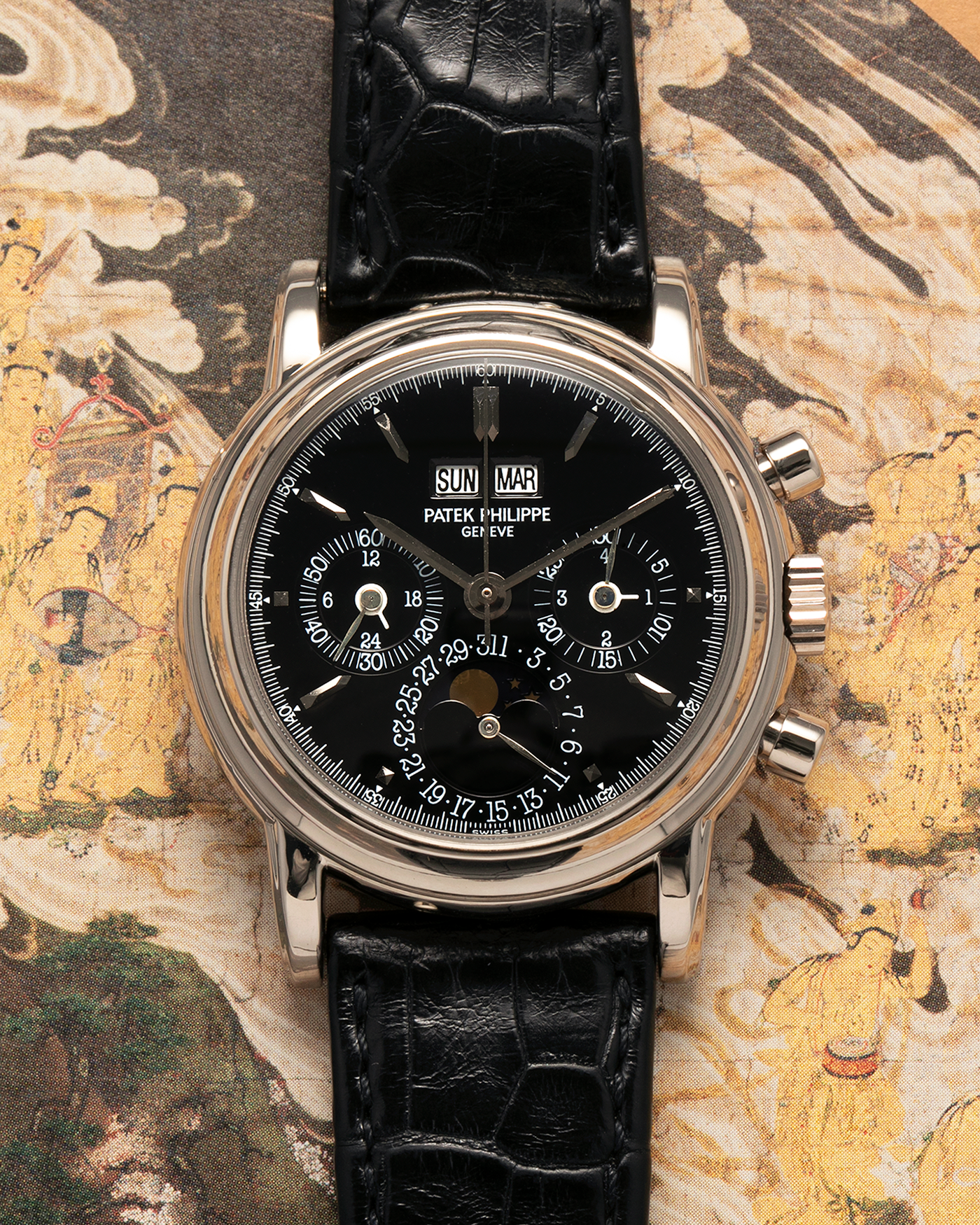 Brand: Patek Philippe
Year: 1995
Model: Perpetual Calendar Chronograph ‘4th Series’
Reference Number: 3970EG
Material: 18-carat White Gold
Movement: Patek Philippe Cal. 27-70 Q (Based on Lemania Cal. 2310), Self-Winding
Movement Number: 3045XXX
Case Dimensions: 36mm x 13mm (43.3mm Lug-to-Lug)
Lug Width: 19mm
Strap: Patek Philippe Black Alligator Leather Strap with Signed 18-carat White Gold Deployant Clasp