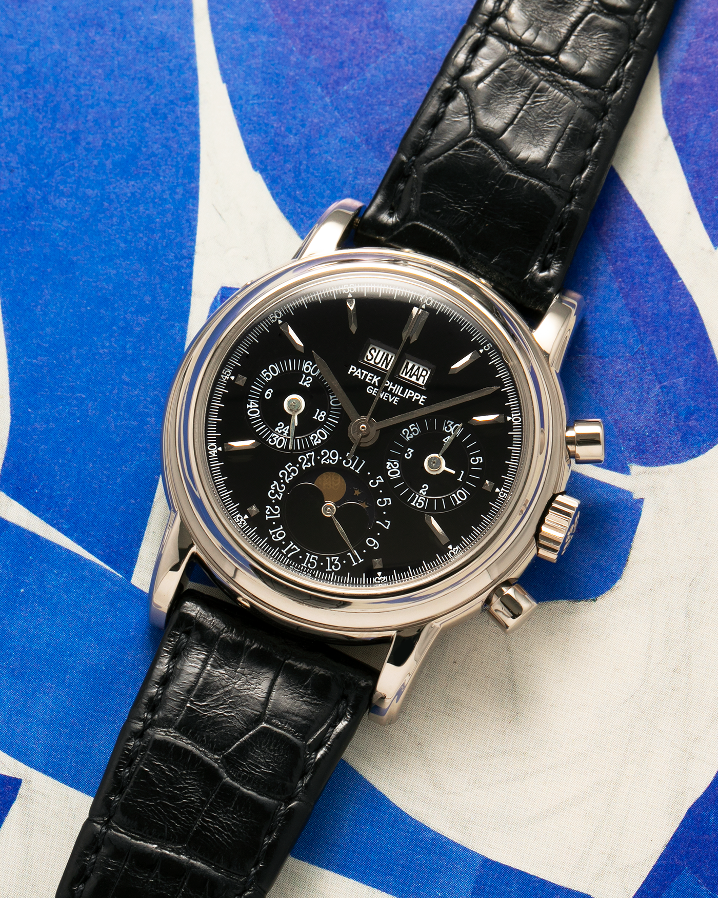 Brand: Patek Philippe
Year: 1995
Model: Perpetual Calendar Chronograph ‘4th Series’
Reference Number: 3970EG
Material: 18-carat White Gold
Movement: Patek Philippe Cal. 27-70 Q (Based on Lemania Cal. 2310), Self-Winding
Movement Number: 3045XXX
Case Dimensions: 36mm x 13mm (43.3mm Lug-to-Lug)
Lug Width: 19mm
Strap: Patek Philippe Black Alligator Leather Strap with Signed 18-carat White Gold Deployant Clasp