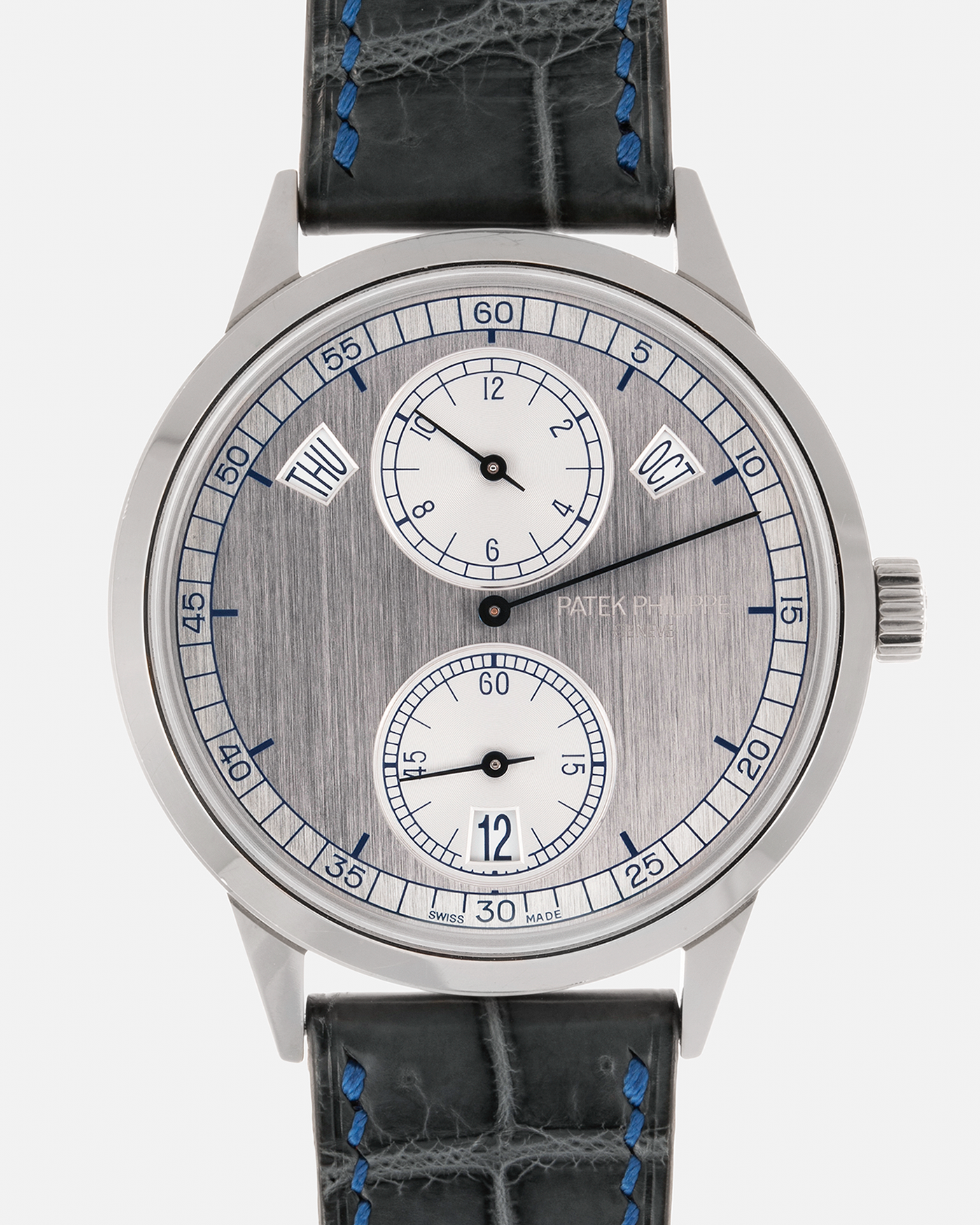 Brand: Patek Philippe Year: 2018 Model: Regulator Annual Calendar Reference Number: 5235G Material: 18-carat White Gold Movement: Patek Philippe Cal. 31-260 REG QA, Self-Winding Case Diameter: 40.5mm Lug Width: 20mm Strap: Dream Rocketeers Grey Alligator Leather Strap with Blue Contrasting Stitching with Signed 18-carat White Gold Tang Buckle, and additional Patek Philippe Black Alligator Leather Strap