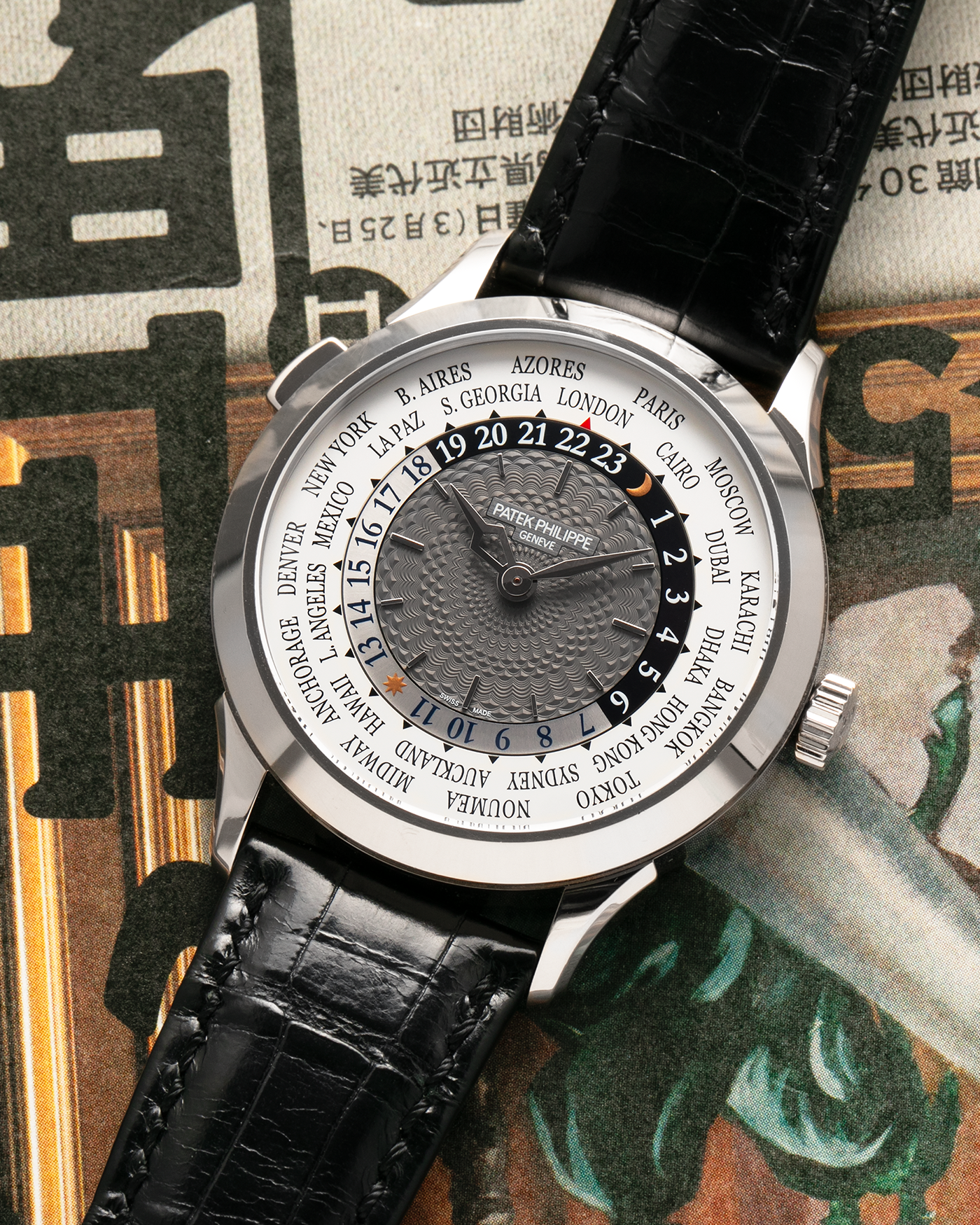 Brand: Patek Philippe
Year: 2018
Model: World Time
Reference: 5230G
Material: 18-carat White Gold
Movement: Patek Philippe Cal. 240 HU Micro Rotor, Self-Winding
Case Dimensions: 38.5mm x 10.3mm (Lug-to-Lug 47mm)
Lug Width: 20mm
Strap: Patek Philippe Black Alligator Leather Strap with Signed 18-carat White Gold Deployant Clasp