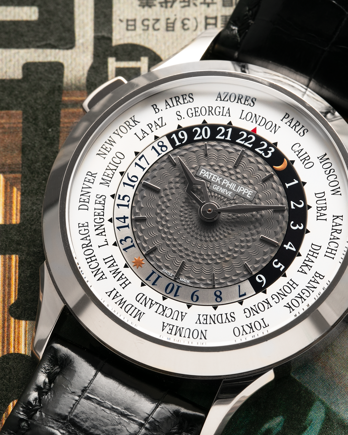 Brand: Patek Philippe
Year: 2018
Model: World Time
Reference: 5230G
Material: 18-carat White Gold
Movement: Patek Philippe Cal. 240 HU Micro Rotor, Self-Winding
Case Dimensions: 38.5mm x 10.3mm (Lug-to-Lug 47mm)
Lug Width: 20mm
Strap: Patek Philippe Black Alligator Leather Strap with Signed 18-carat White Gold Deployant Clasp