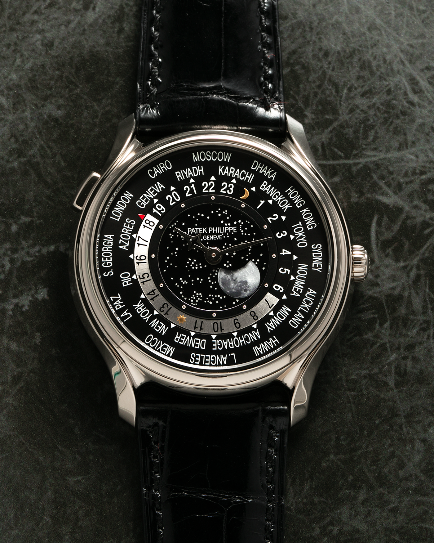 Brand: Patek Philippe Year: 2015 Model: World Time Moon, Limited Edition of 1300 pieces Reference Number: 5575G Material: 18-carat White Gold Movement: Patek Philippe Cal. 240 HU LU Micro-Rotor, Self-Winding Case Diameter: 40mm Lug Width: 20mm Strap: Patek Philippe Black Alligator Leather Strap with Signed / Engraved 18-carat White Gold Deployant Clasp