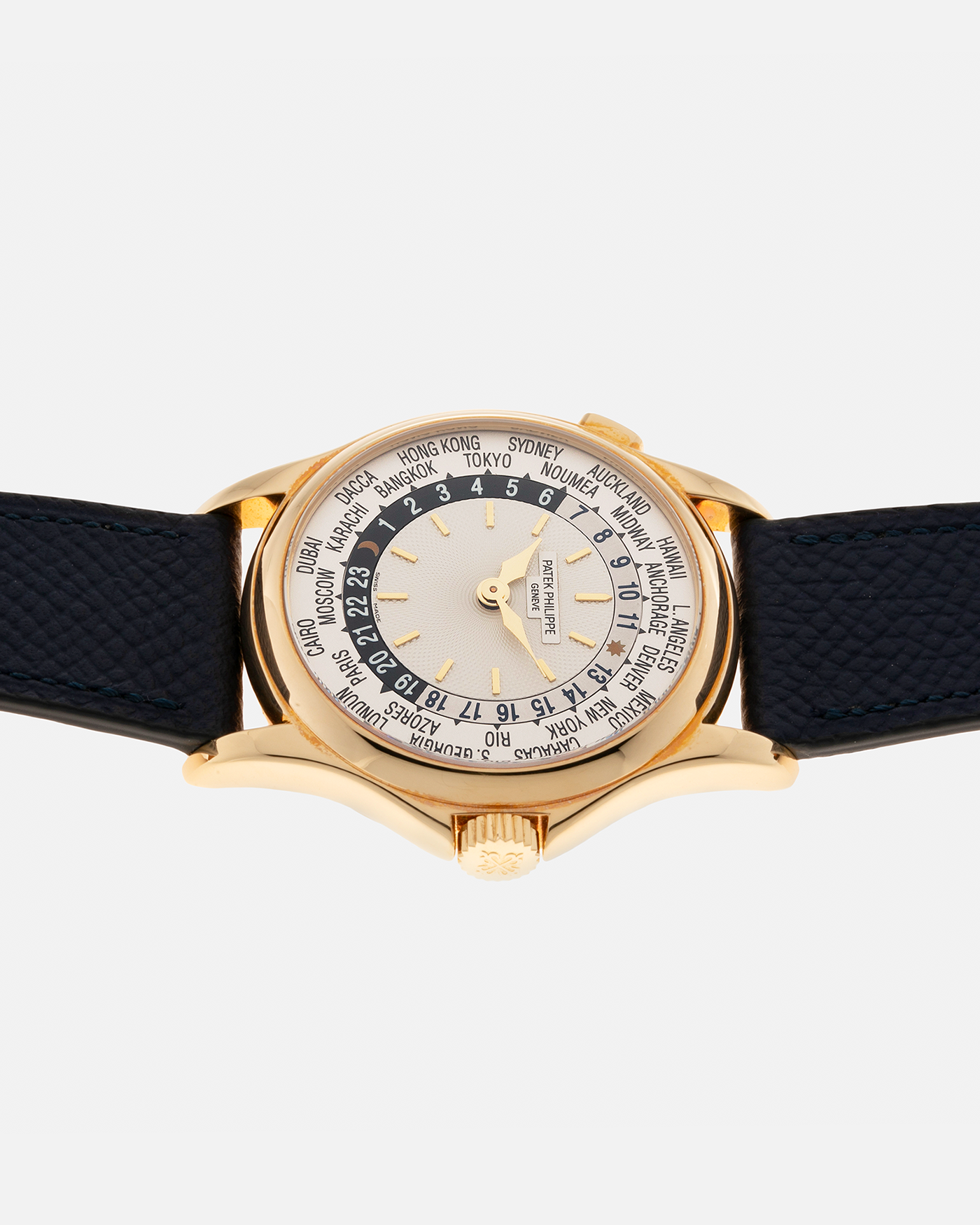 Brand: Patek Philippe Year: 2000s Model: World Time Reference Number: 5110J Material: 18-carat Yellow Gold Movement: Patek Philippe Cal. 240 HU Micro-Rotor, Self-Winding Case Diameter: 37mm Lug Width: 20mm Bracelet: Nostime Navy Blue Textured Calf Leather Strap with Signed 18-carat Yellow Gold Deployant Clasp, Patek Philippe Brown Alligator Leather Strap (Used)