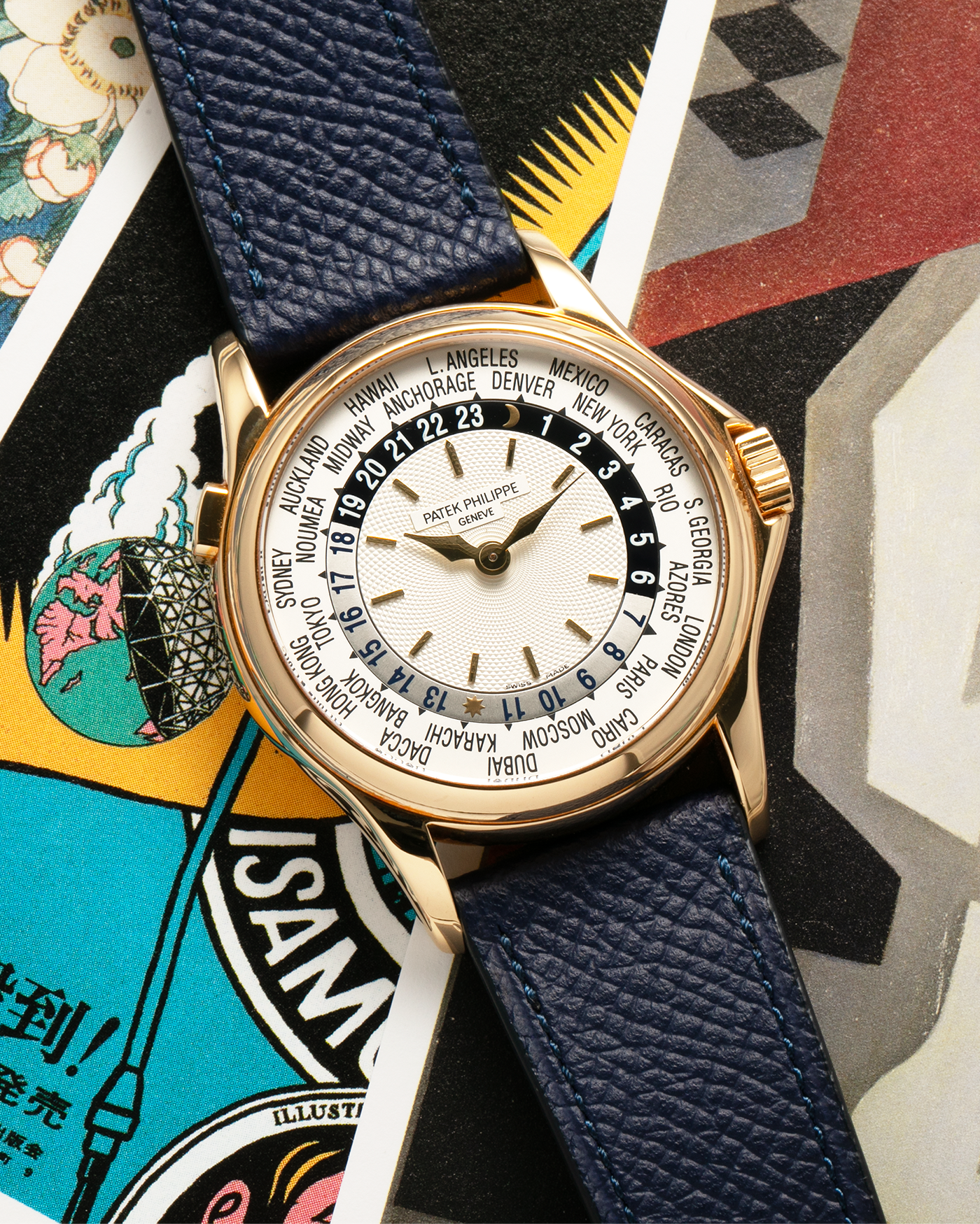 Brand: Patek Philippe Year: 2000s Model: World Time Reference Number: 5110J Material: 18-carat Yellow Gold Movement: Patek Philippe Cal. 240 HU Micro-Rotor, Self-Winding Case Diameter: 37mm Lug Width: 20mm Bracelet: Nostime Navy Blue Textured Calf Leather Strap with Signed 18-carat Yellow Gold Deployant Clasp, Patek Philippe Brown Alligator Leather Strap (Used)