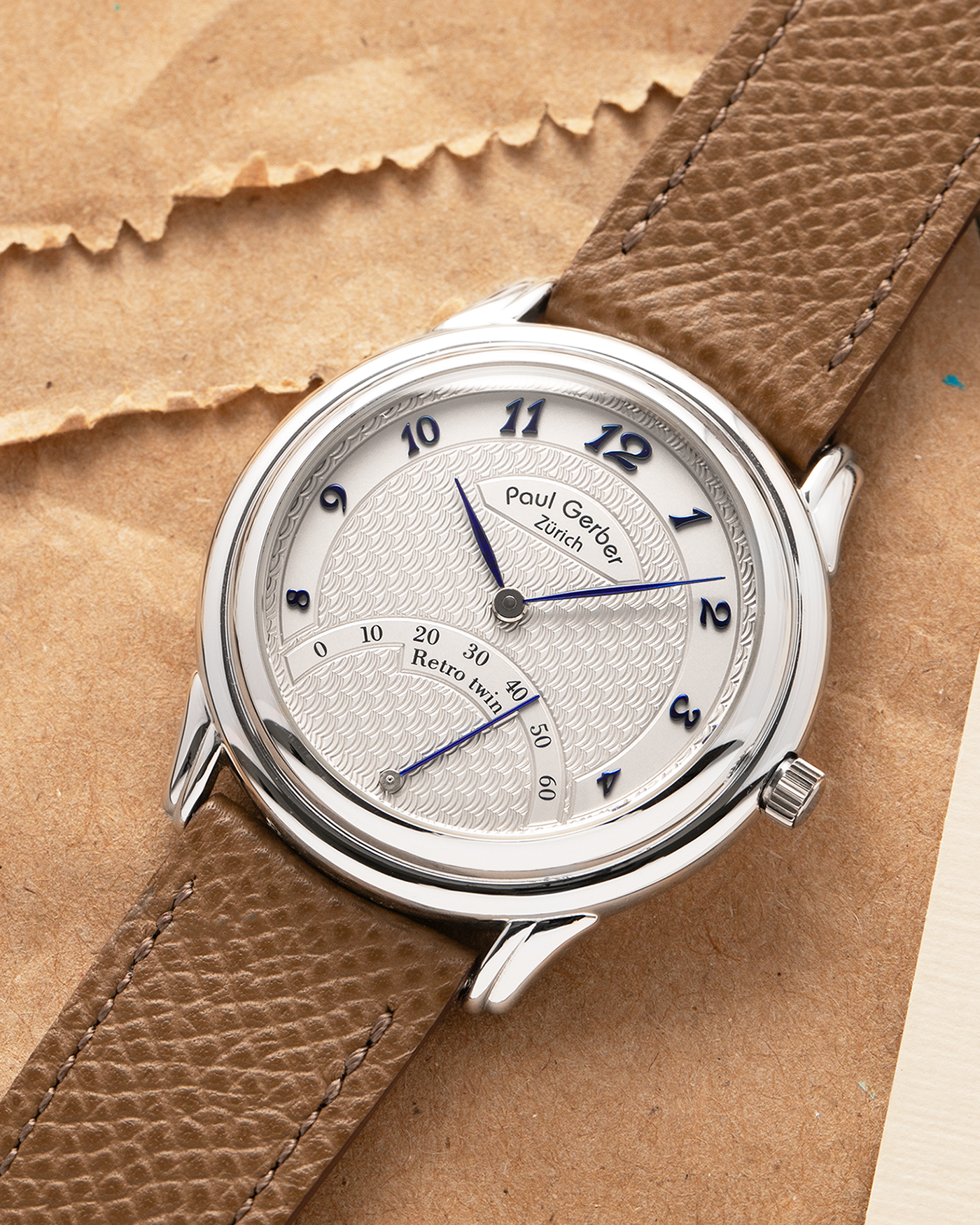 Brand: Paul Gerber
Year: 2000’s
Model: Retro Twin
Reference: 157
Material: 18-carat White Gold
Movement: Self-Winding Paul Gerber Cal. 15 (Heavily-Modified Peseux Cal. 7001)
Case Dimensions: 36mm Diameter 11mm Thickness
Lug Width: 18mm
Strap: Paul Gerber Dark Brown Calf Leather Strap with Signed 18-carat Yellow Gold Tang Buckle