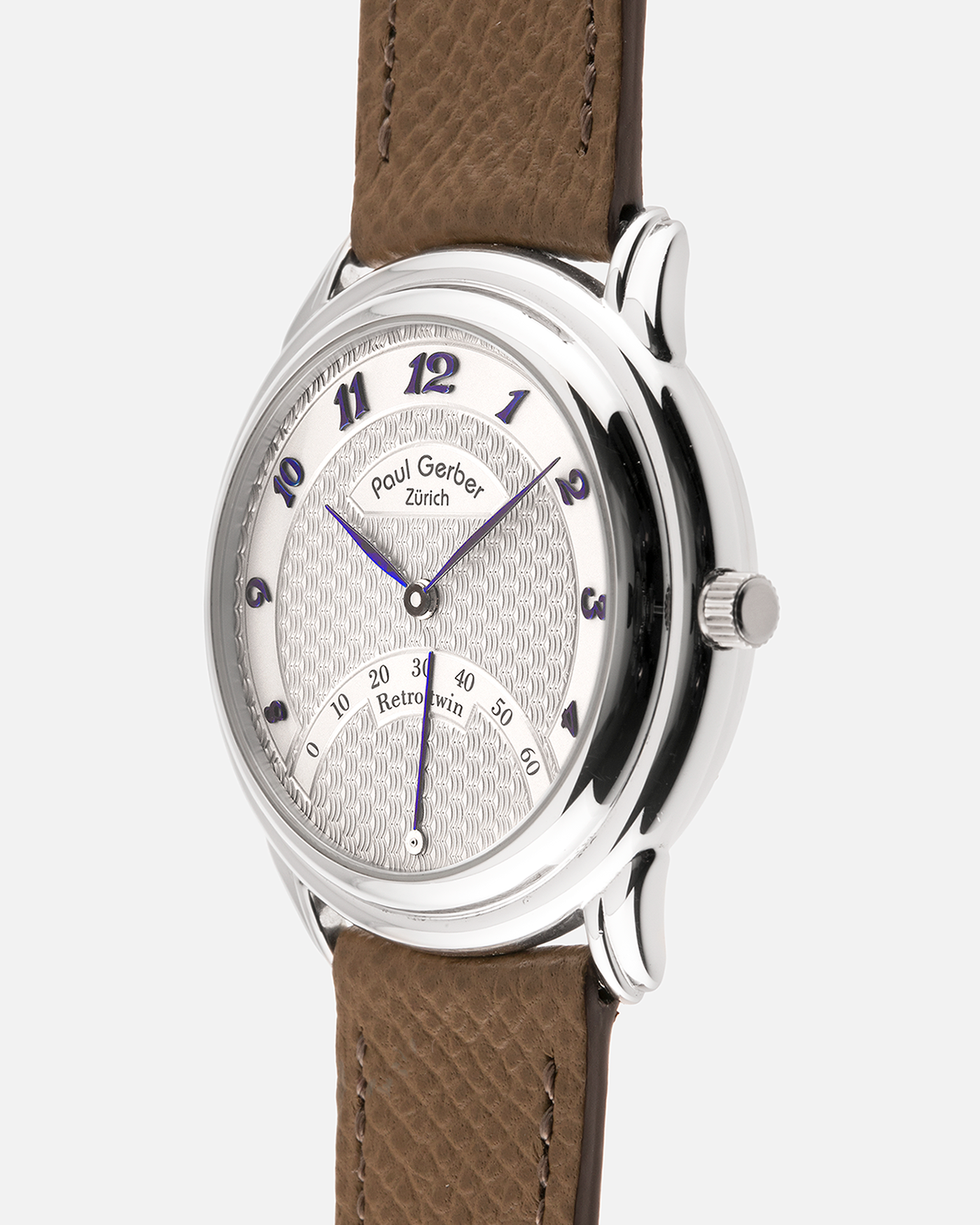 Brand: Paul Gerber
Year: 2000’s
Model: Retro Twin
Reference: 157
Material: 18-carat White Gold
Movement: Self-Winding Paul Gerber Cal. 15 (Heavily-Modified Peseux Cal. 7001)
Case Dimensions: 36mm Diameter 11mm Thickness
Lug Width: 18mm
Strap: Paul Gerber Dark Brown Calf Leather Strap with Signed 18-carat Yellow Gold Tang Buckle