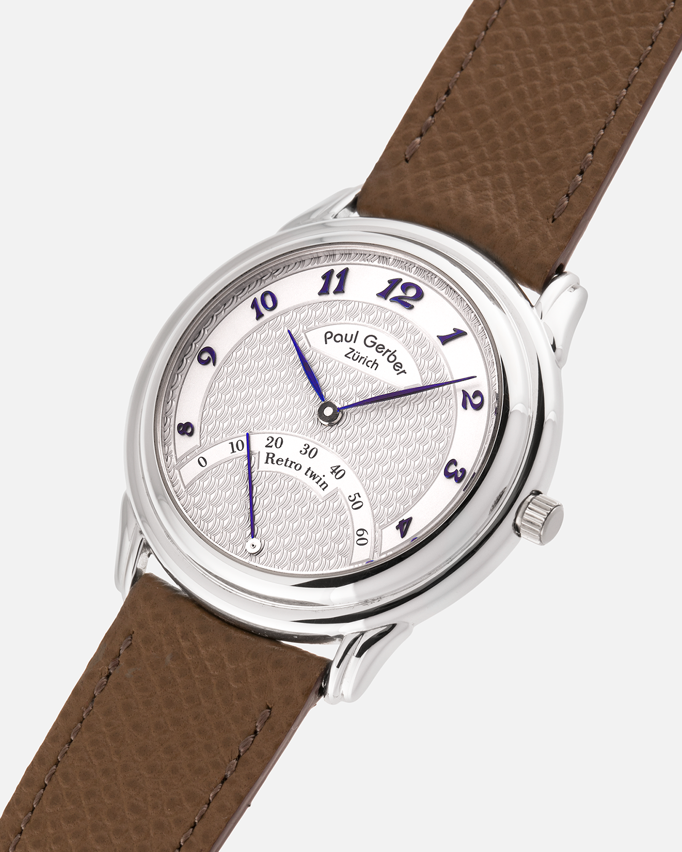 Brand: Paul Gerber
Year: 2000’s
Model: Retro Twin
Reference: 157
Material: 18-carat White Gold
Movement: Self-Winding Paul Gerber Cal. 15 (Heavily-Modified Peseux Cal. 7001)
Case Dimensions: 36mm Diameter 11mm Thickness
Lug Width: 18mm
Strap: Paul Gerber Dark Brown Calf Leather Strap with Signed 18-carat Yellow Gold Tang Buckle