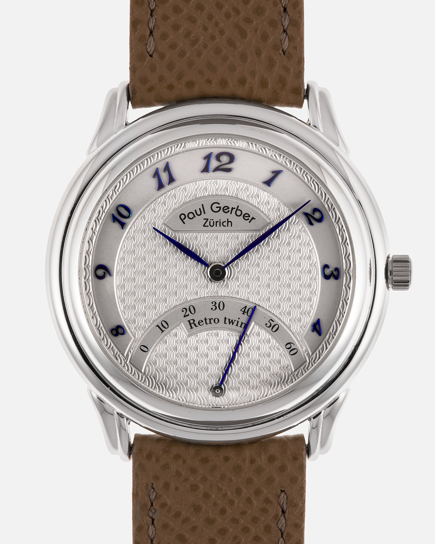 Brand: Paul Gerber
Year: 2000’s
Model: Retro Twin
Reference: 157
Material: 18-carat White Gold
Movement: Self-Winding Paul Gerber Cal. 15 (Heavily-Modified Peseux Cal. 7001)
Case Dimensions: 36mm Diameter 11mm Thickness
Lug Width: 18mm
Strap: Paul Gerber Dark Brown Calf Leather Strap with Signed 18-carat Yellow Gold Tang Buckle