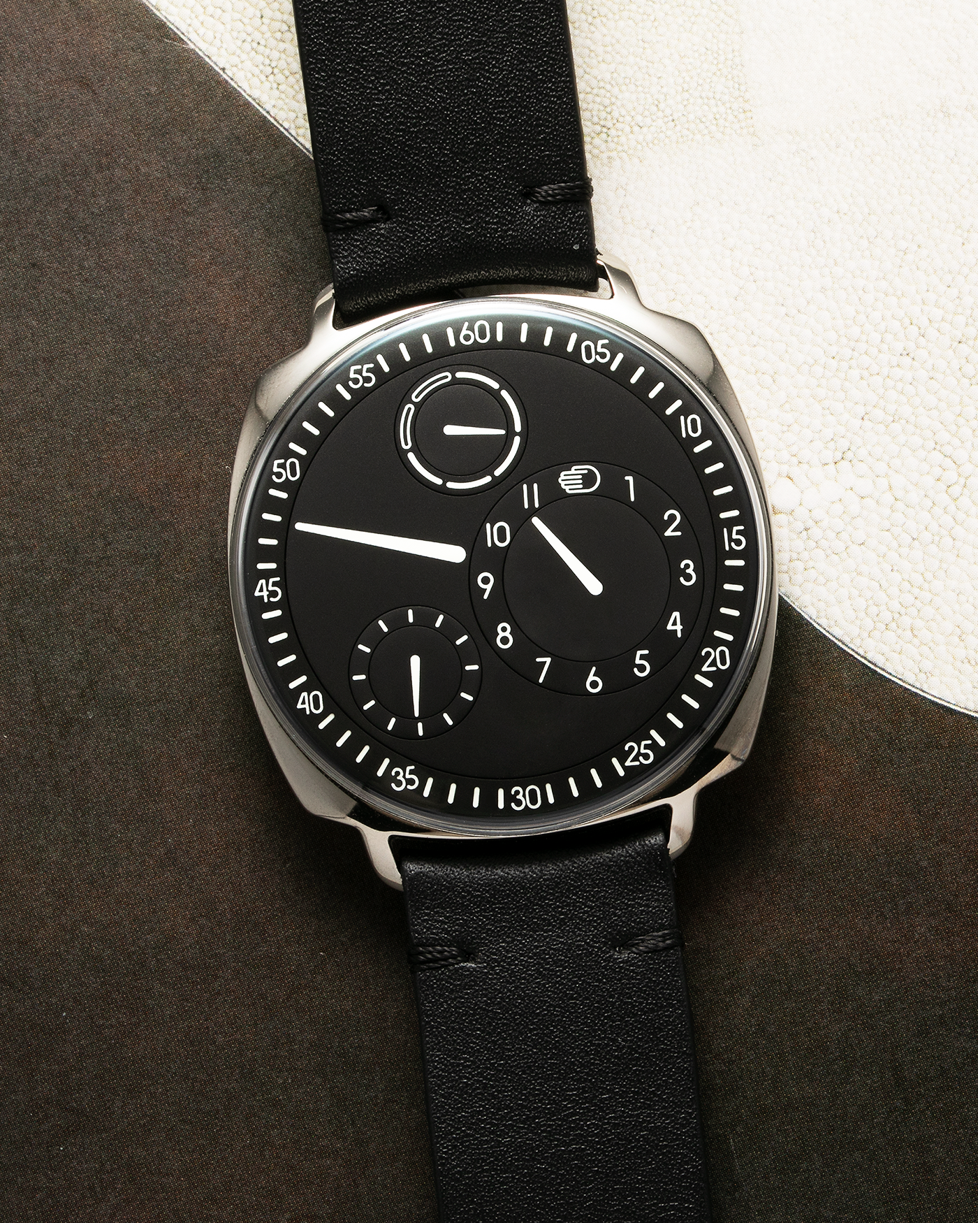 Brand: Ressence Year: 2022 Model: Type 1² Black Material: Polished Grade 5 Titanium with Satin Finished Caseback Movement: Customised ETA Cal. 2894/2 Base with In-House Patented Ressence Orbital Convex System (ROCS) 1 Module Driven by Minute Axle, Self-Winding Case Dimensions: 42mm Bracelet/Strap: Ressence Black Calf Leather Strap with Signed Ardillon Buckle