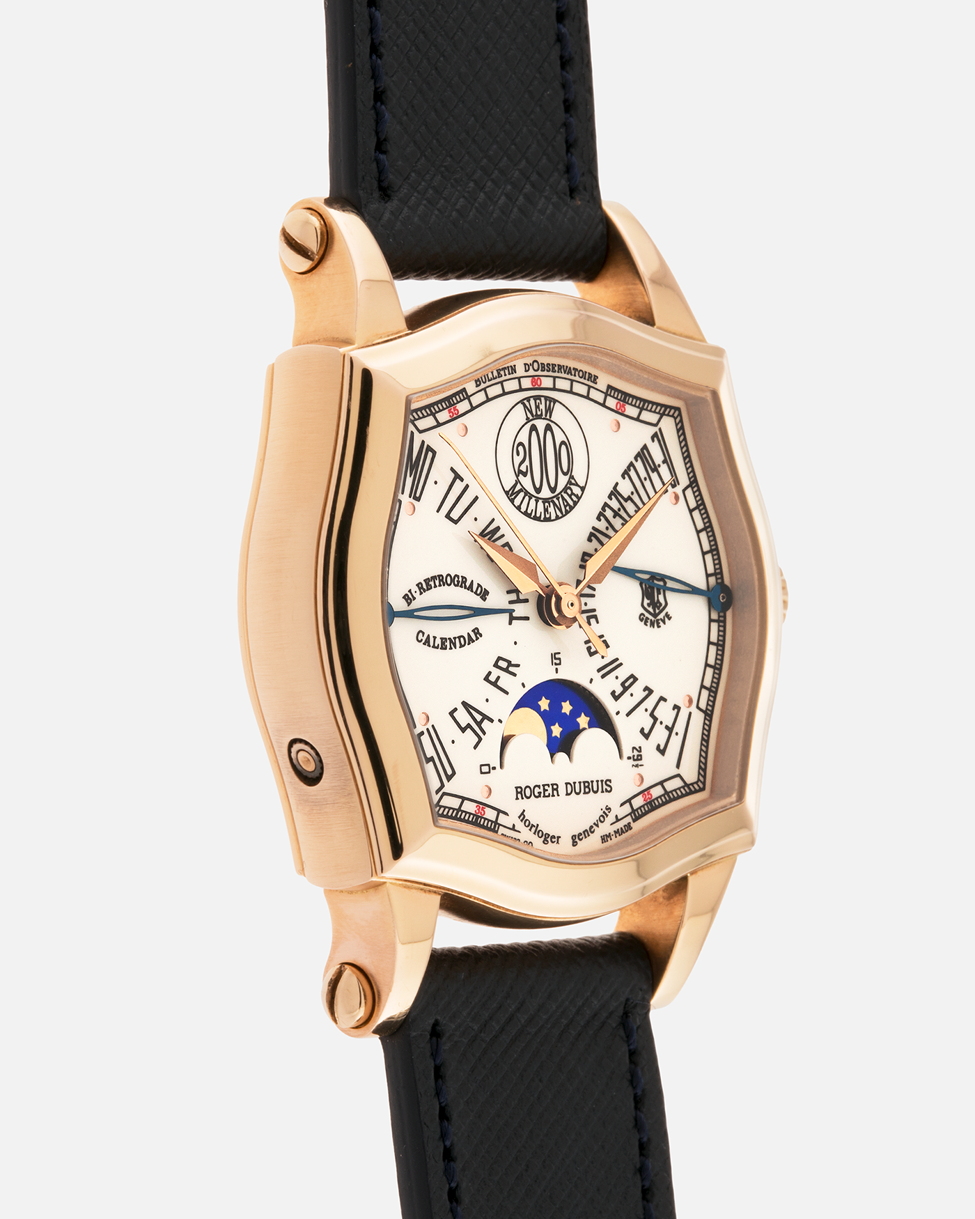 Brand: Roger Dubuis
Year: 2000
Model: Sympathie 37 2000 New Millenary
Material: 18k Rose Gold
Movement: Roger Dubuis Cal. 5740
Case Dimensions: 34mm Diameter 11mm Thickness
Lug Width: 18mm
Strap: Molequin Navy Blue Textured Calf Leather Strap with Signed 18k Rose Gold Tang Buckle